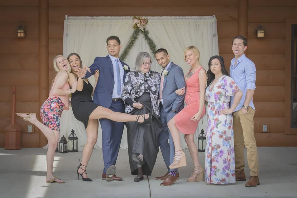 Wedding party posing by a draped backdrop on the patio at Moose Hollow Lodge in Pigeon Forge near Smoky Mountains