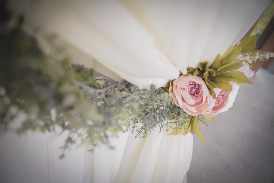 White wedding drapes with pink floral accents and greenery at Moose Hollow Lodge in Pigeon Forge
