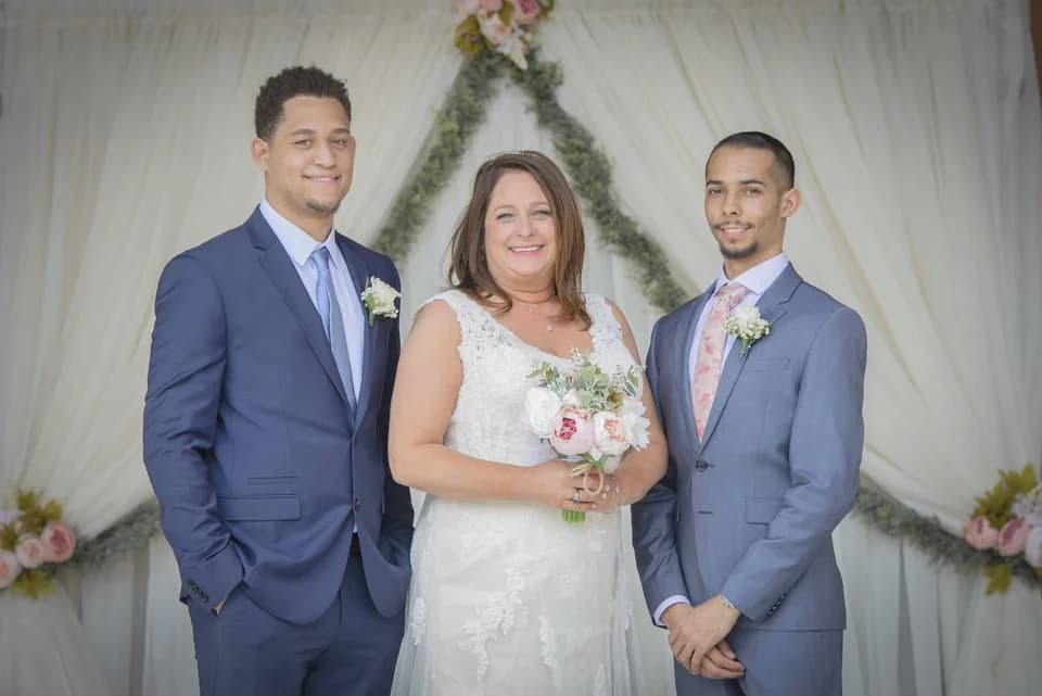 Wedding party in front of white draped ceremony backdrop with florals at Moose Hollow Lodge in Pigeon Forge