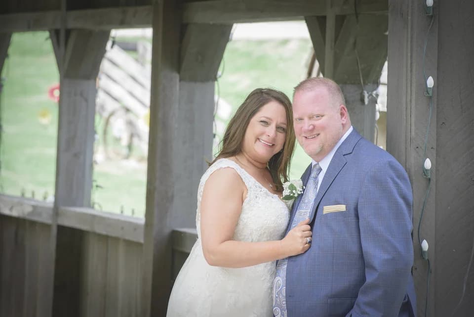 Smiling bride and groom at rustic wedding chapel at Moose Hollow Lodge in Pigeon Forge near Smoky Mountains