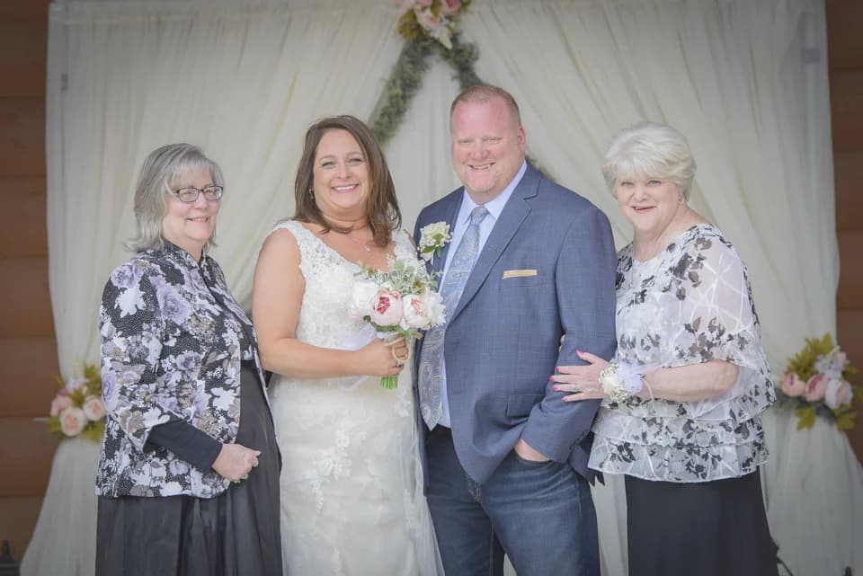Wedding party in front of an elegant white ceremony backdrop at Moose Hollow Lodge in Pigeon Forge