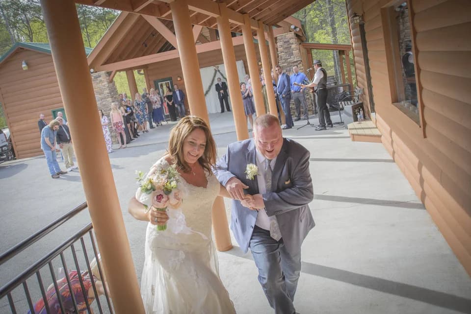 Newlyweds on covered porch at wedding venue Moose Hollow Lodge in Pigeon Forge near the Smoky Mountains