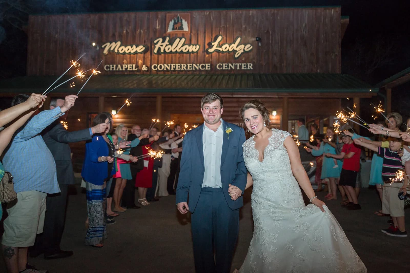 Bride and groom sparkler exit outside the rustic chapel at Moose Hollow Lodge in Pigeon Forge near Smoky Mountains