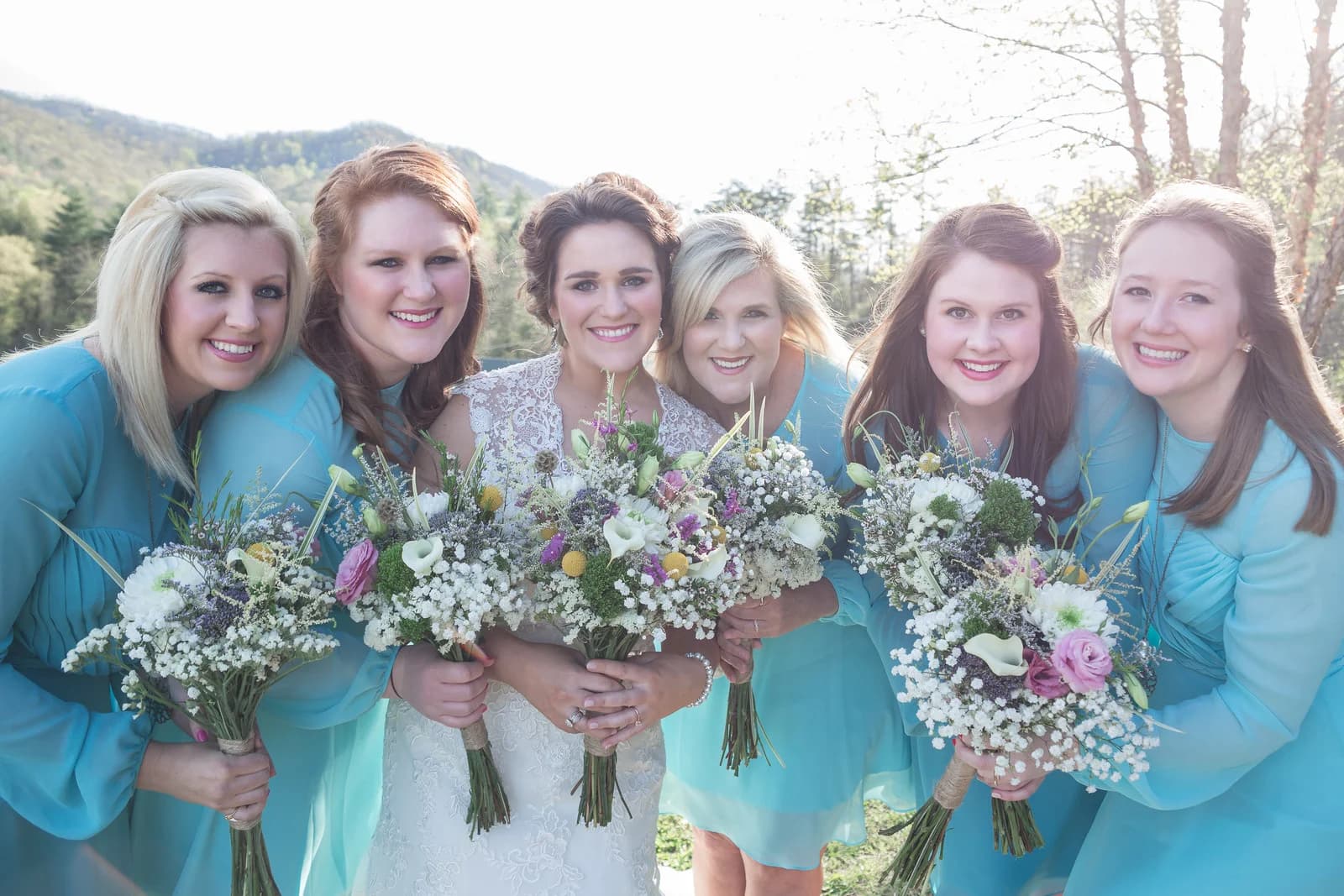 Bride and bridesmaids with wildflower bouquets at Moose Hollow Lodge in Pigeon Forge near Smoky Mountains and Dollywood