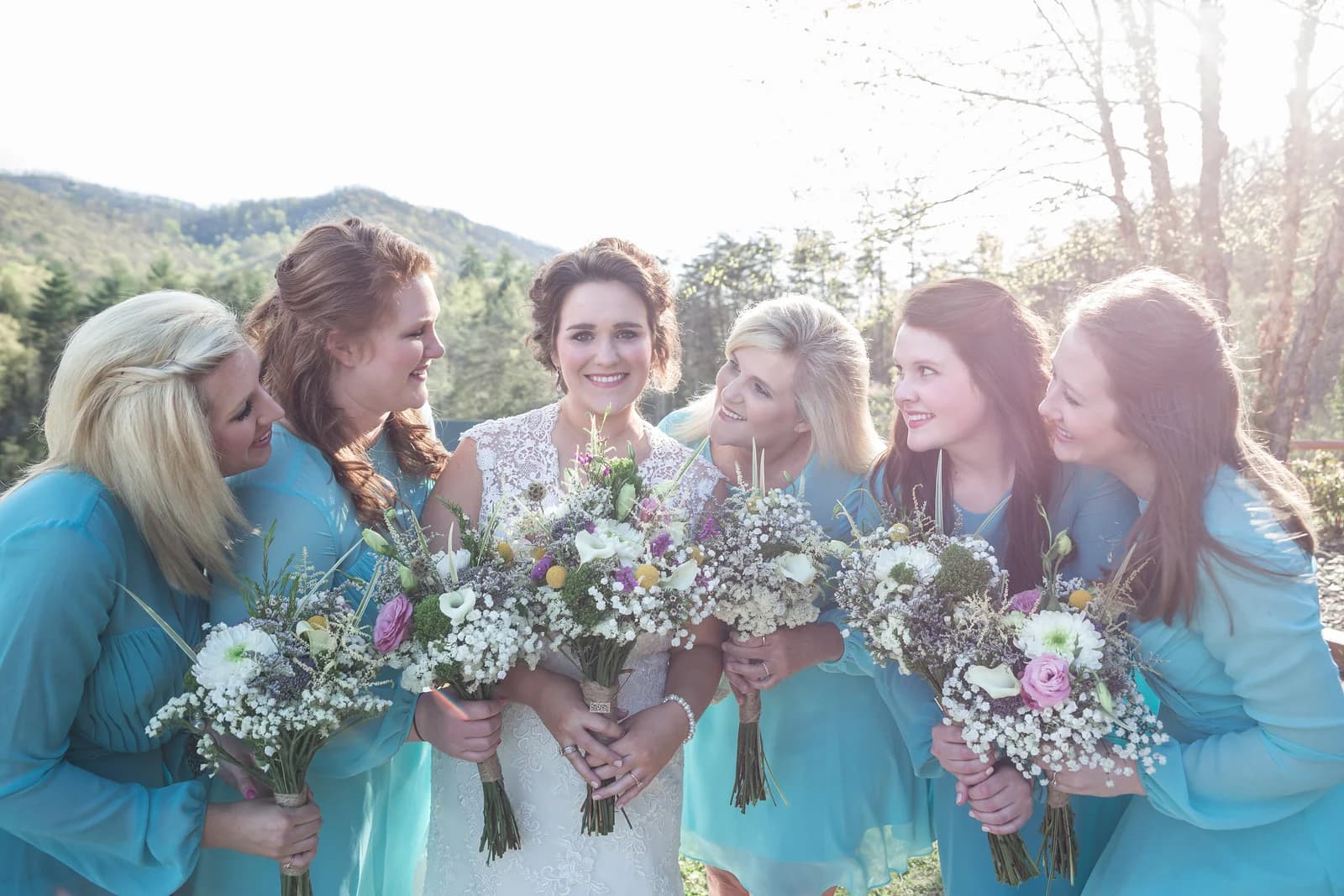 Bride and bridesmaids with bouquets and Smoky Mountain views at Moose Hollow Lodge in Pigeon Forge near Dollywood