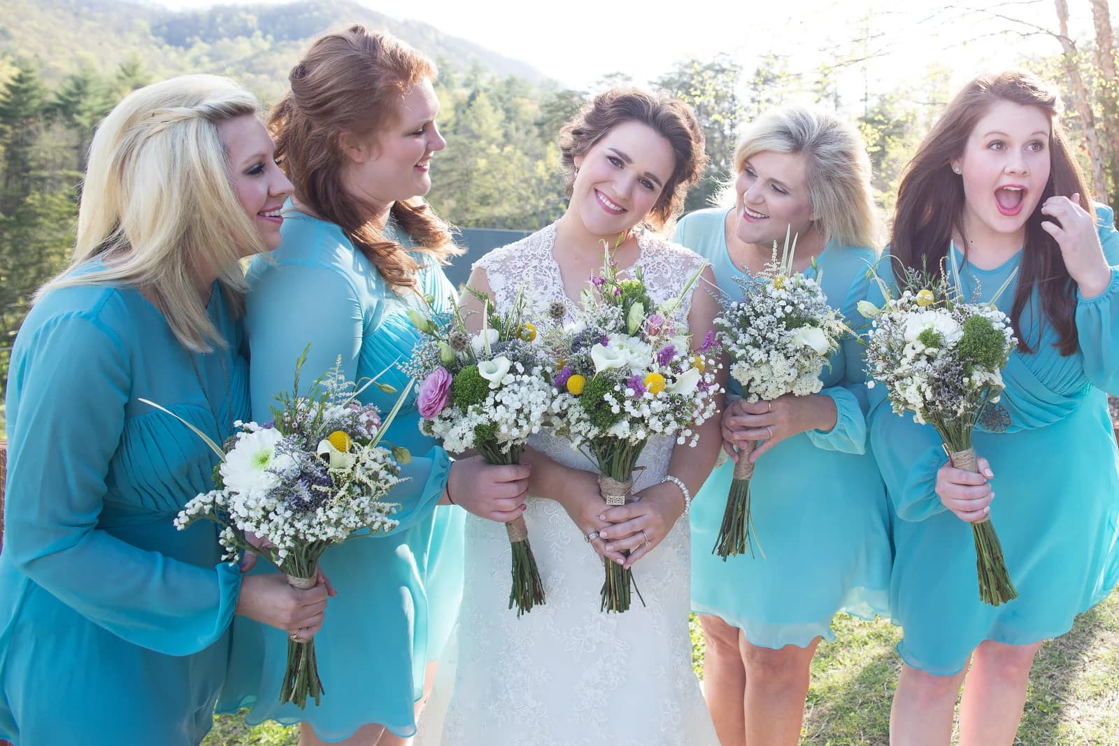 Bride and bridesmaids with bouquets and mountain views at Moose Hollow Lodge in Pigeon Forge near the Smoky Mountains