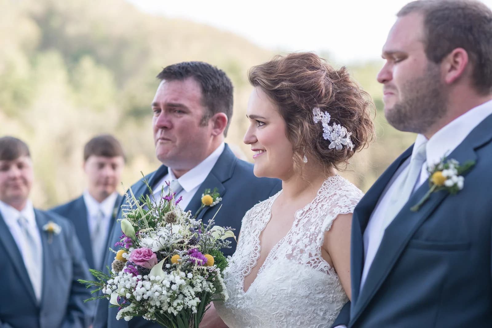 Bride with bouquet at outdoor wedding ceremony in the Smoky Mountains at Moose Hollow Lodge in Pigeon Forge