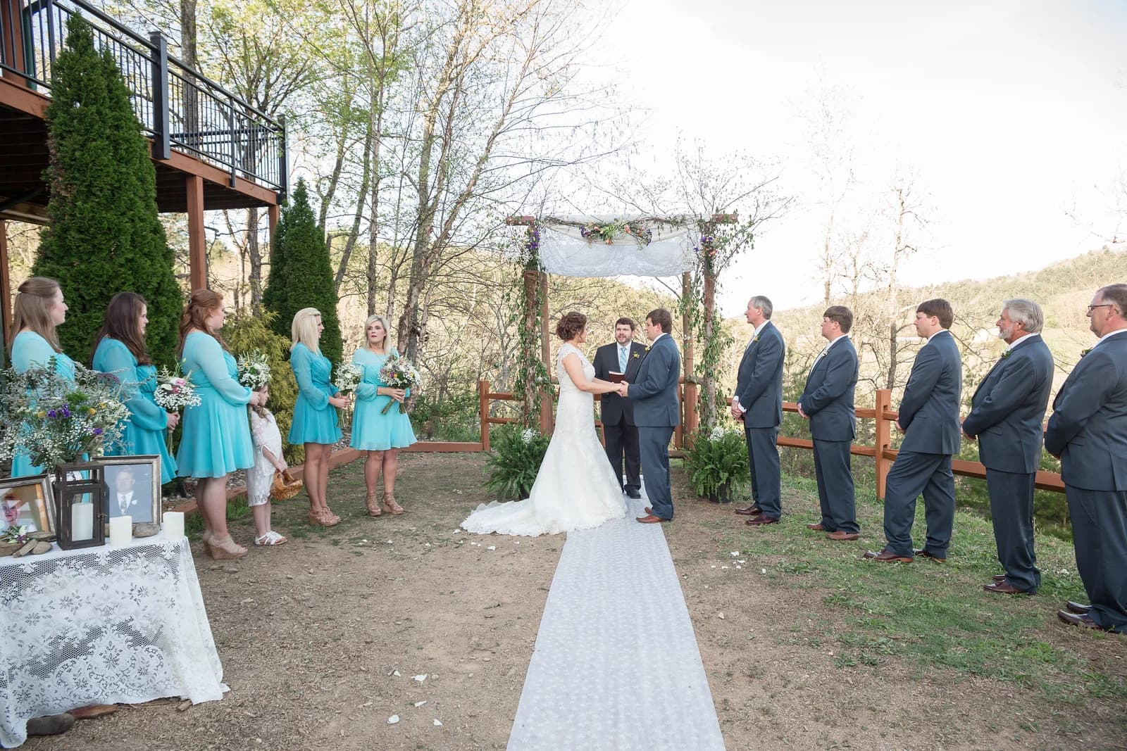 Outdoor wedding ceremony under floral arbor with forest views near Dollywood at Moose Hollow Lodge in Pigeon Forge