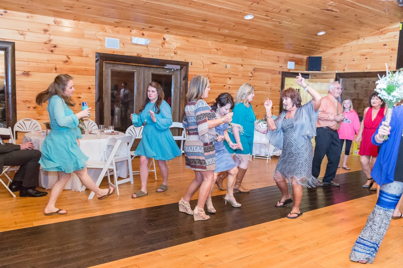 Spacious wedding reception hall with wood-paneled walls and dance floor at Moose Hollow Lodge in Pigeon Forge