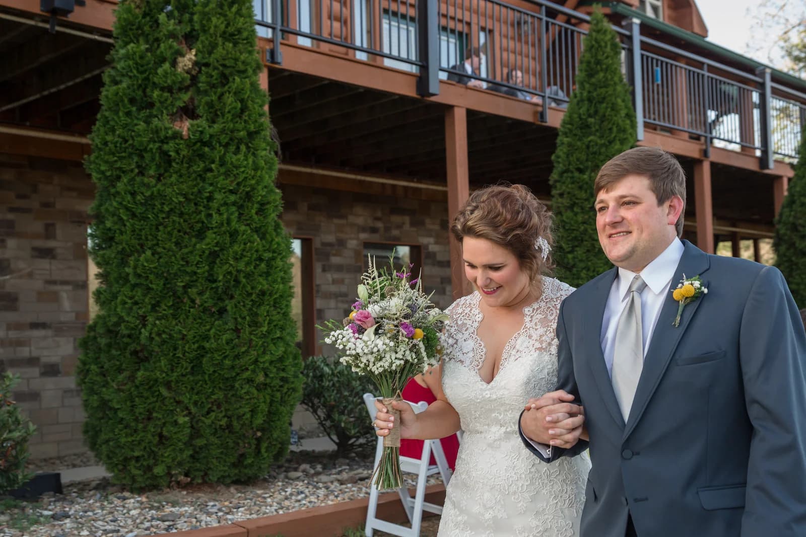 Bride and groom outside rustic log cabin venue at Moose Hollow Lodge in Pigeon Forge near Smoky Mountains
