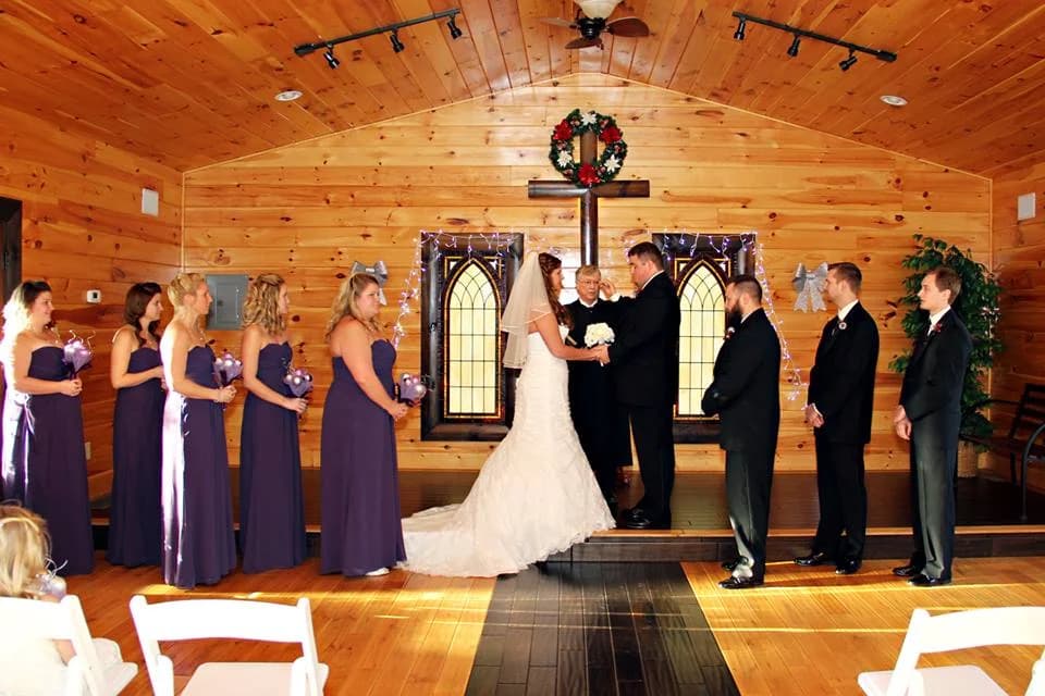 Rustic wood wedding chapel with stained glass and cross at Moose Hollow Lodge in Pigeon Forge