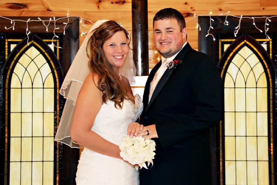 Rustic wedding chapel with stained glass windows and happy couple at Moose Hollow Lodge in Pigeon Forge