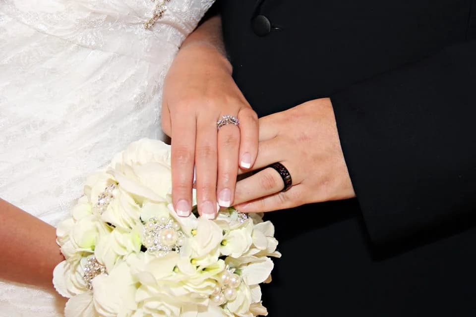 Close-up of wedding rings and white bridal bouquet at Moose Hollow Lodge in Pigeon Forge near the Smoky Mountains.