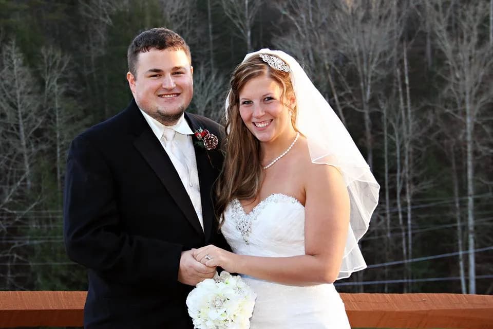 Wedding couple on deck with Smoky Mountains view near Dollywood at Moose Hollow Lodge in Pigeon Forge