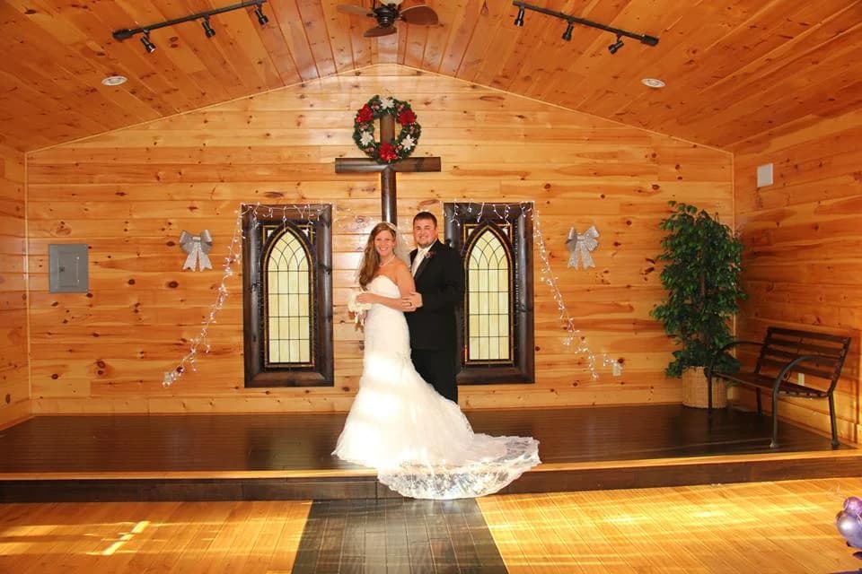 Rustic wood wedding chapel with a stage and decorative cross at Moose Hollow Lodge in Pigeon Forge
