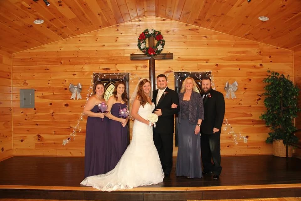 Rustic wood-paneled wedding chapel featuring a large wooden cross at Moose Hollow Lodge in Pigeon Forge.