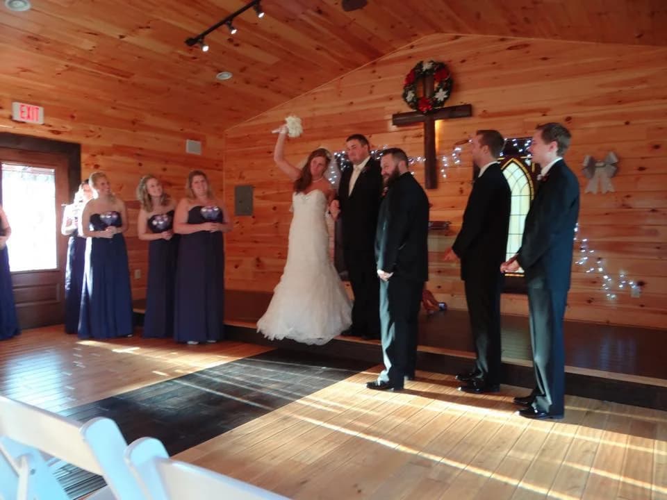 Rustic all-wood wedding chapel interior with ceremony and bridal party at Moose Hollow Lodge in Pigeon Forge