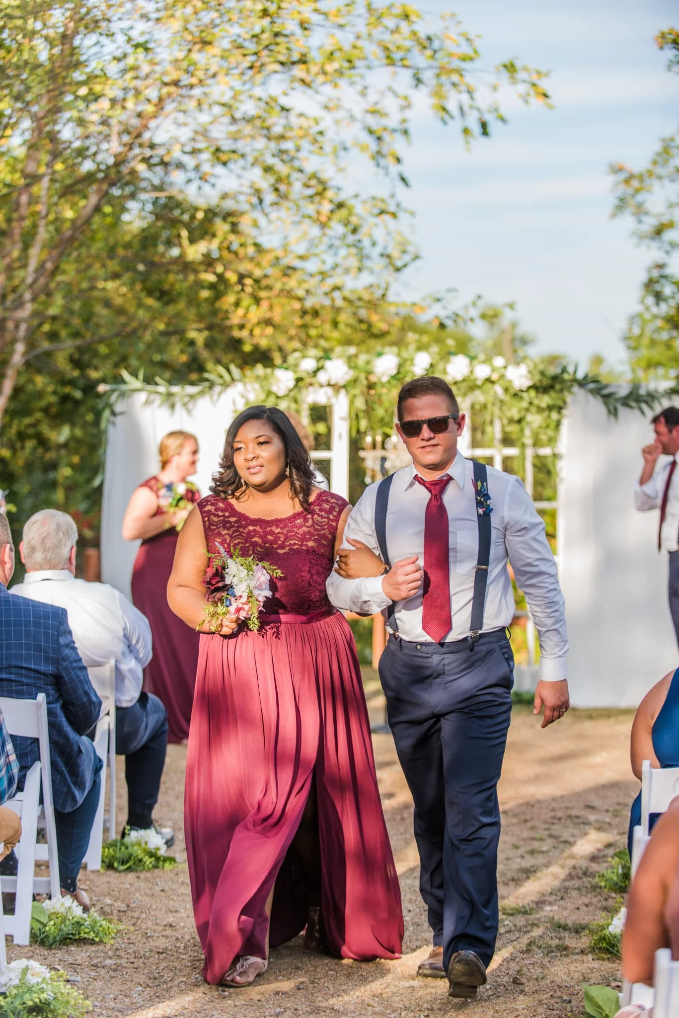 Wedding party walking down an outdoor ceremony aisle at Moose Hollow Lodge in Pigeon Forge near Dollywood