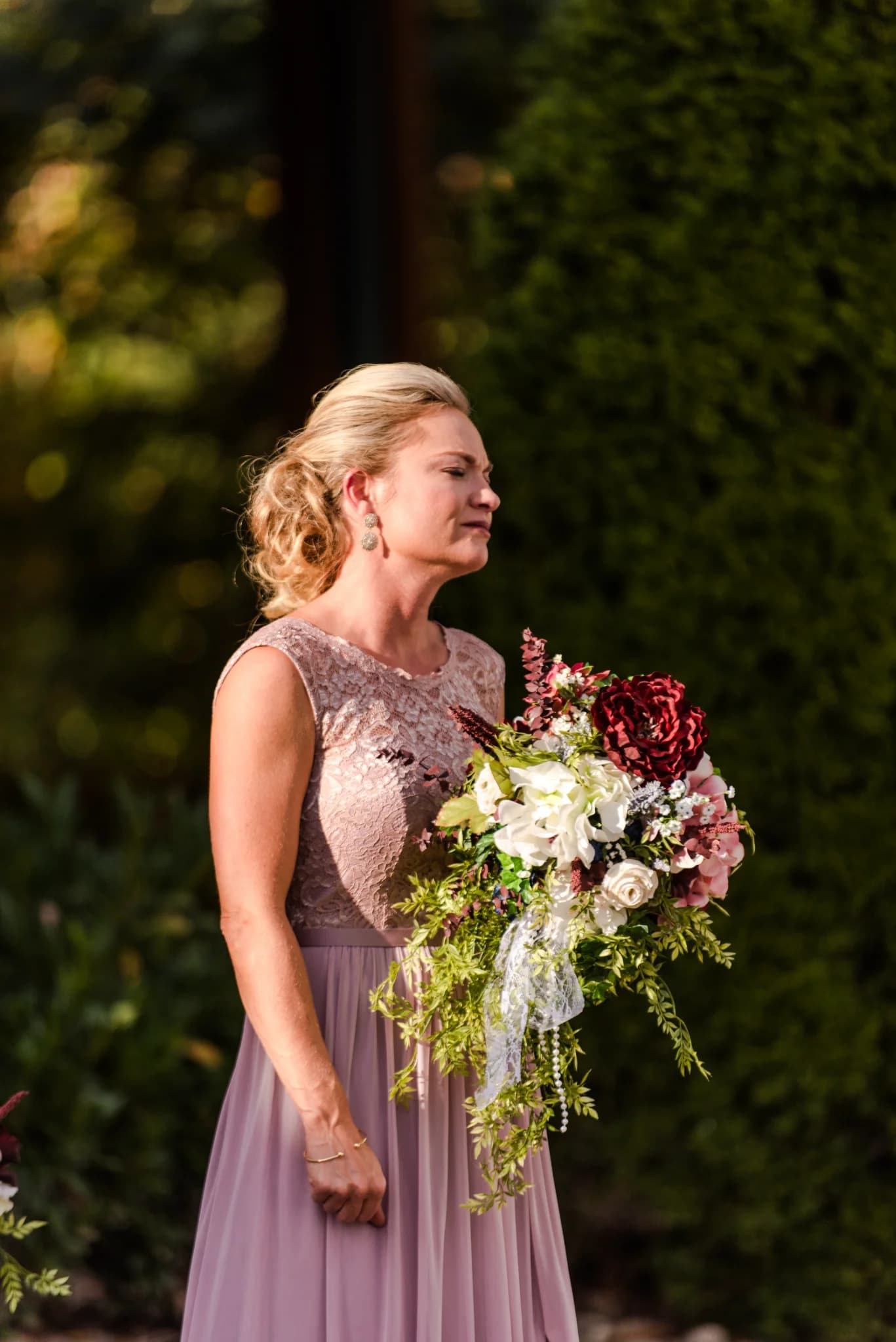 Woman with floral wedding bouquet outdoors near Smoky Mountains at Moose Hollow Lodge in Pigeon Forge