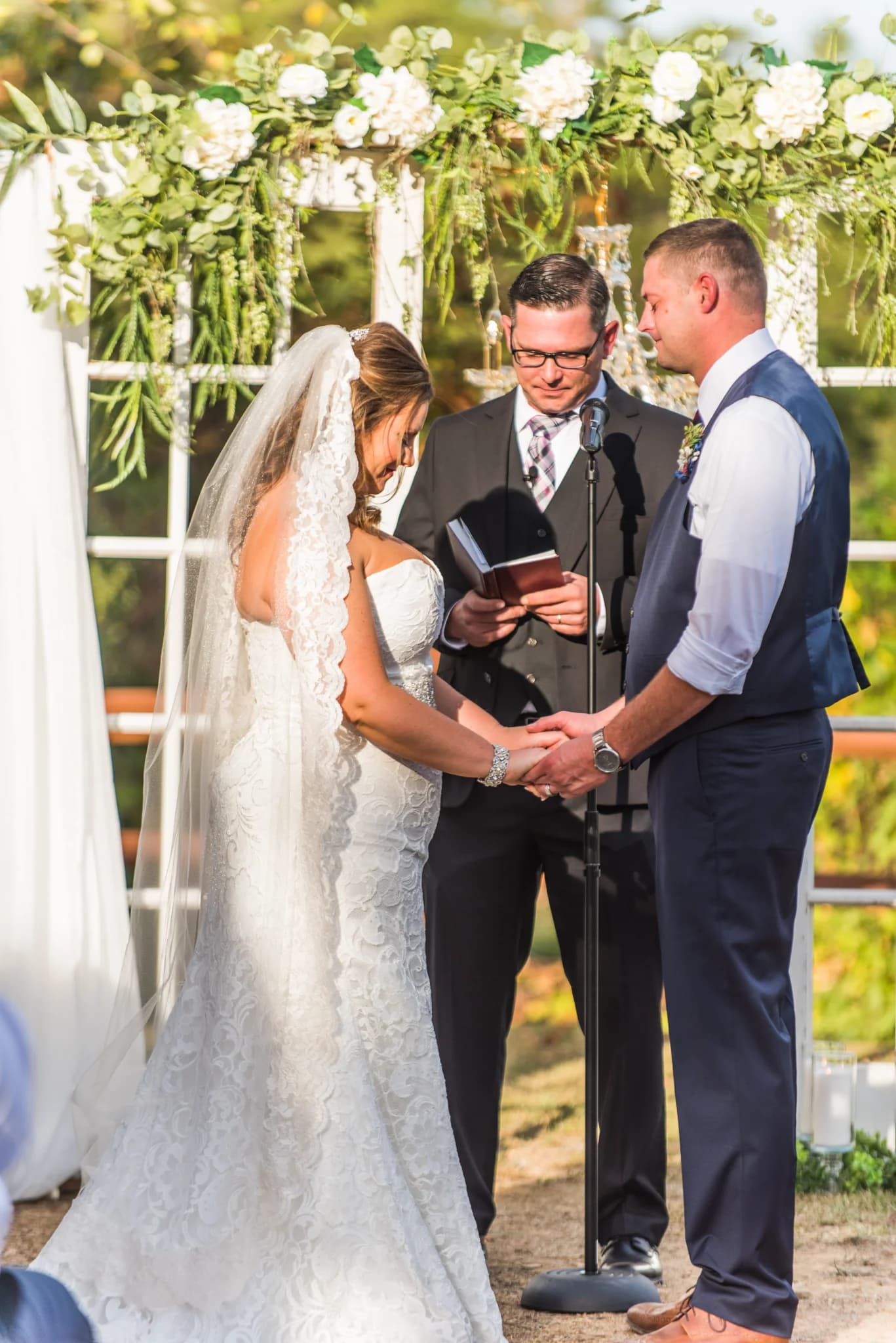 Outdoor wedding ceremony under a floral archway near the Smoky Mountains at Moose Hollow Lodge in Pigeon Forge