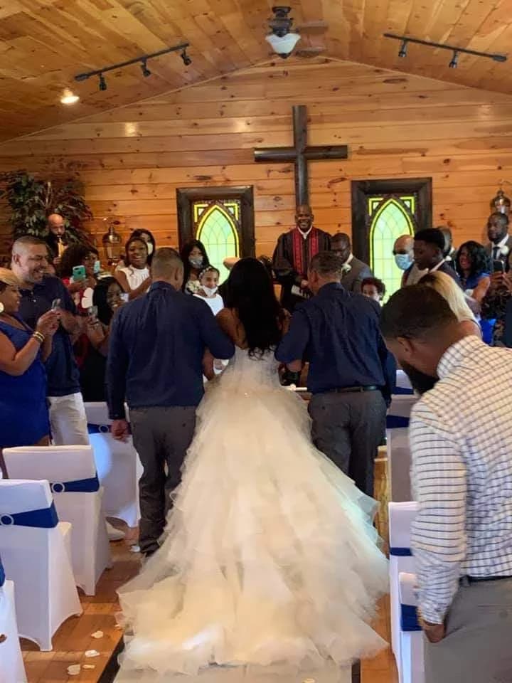 Wedding ceremony in rustic wood-paneled chapel with stained glass at Moose Hollow Lodge in Pigeon Forge