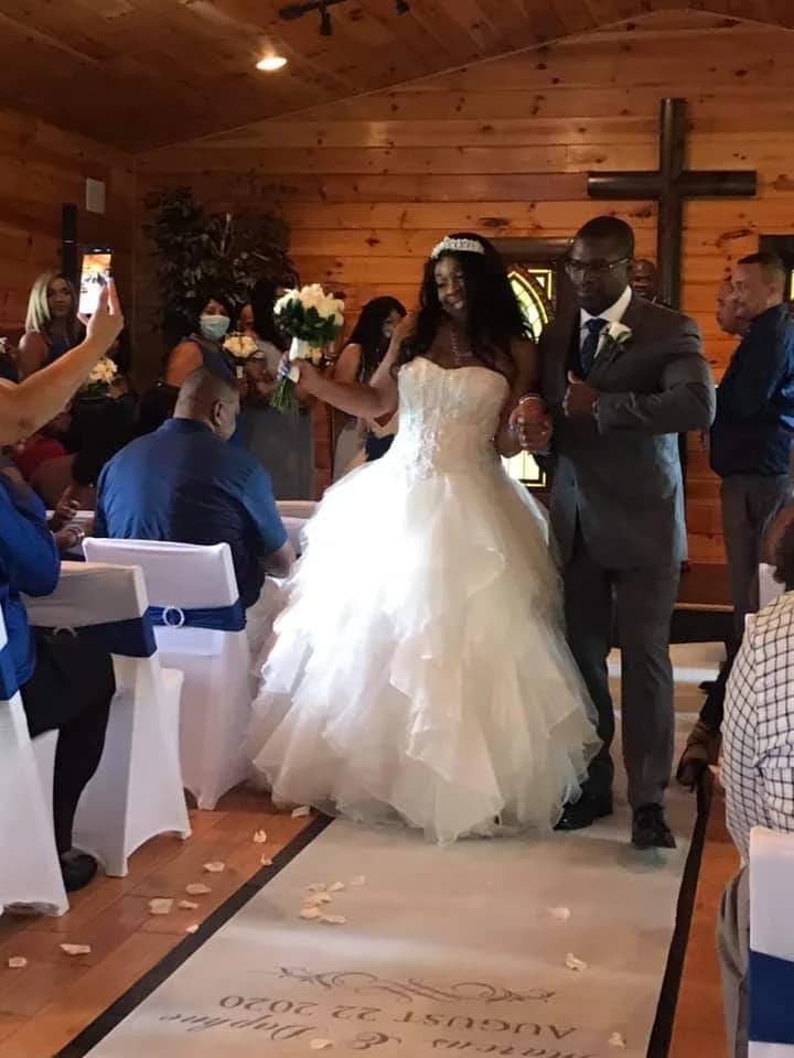 Bride and groom walking down aisle in rustic wood wedding chapel at Moose Hollow Lodge in Pigeon Forge