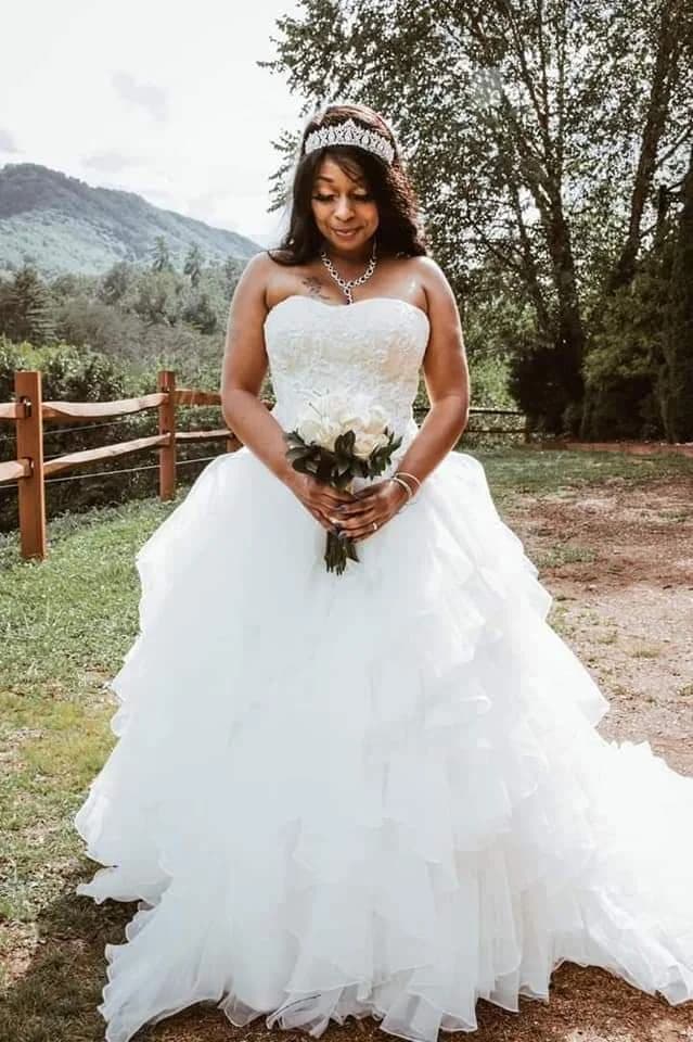 Bride in ruffled white gown with mountain views at Moose Hollow Lodge in Pigeon Forge near the Smoky Mountains