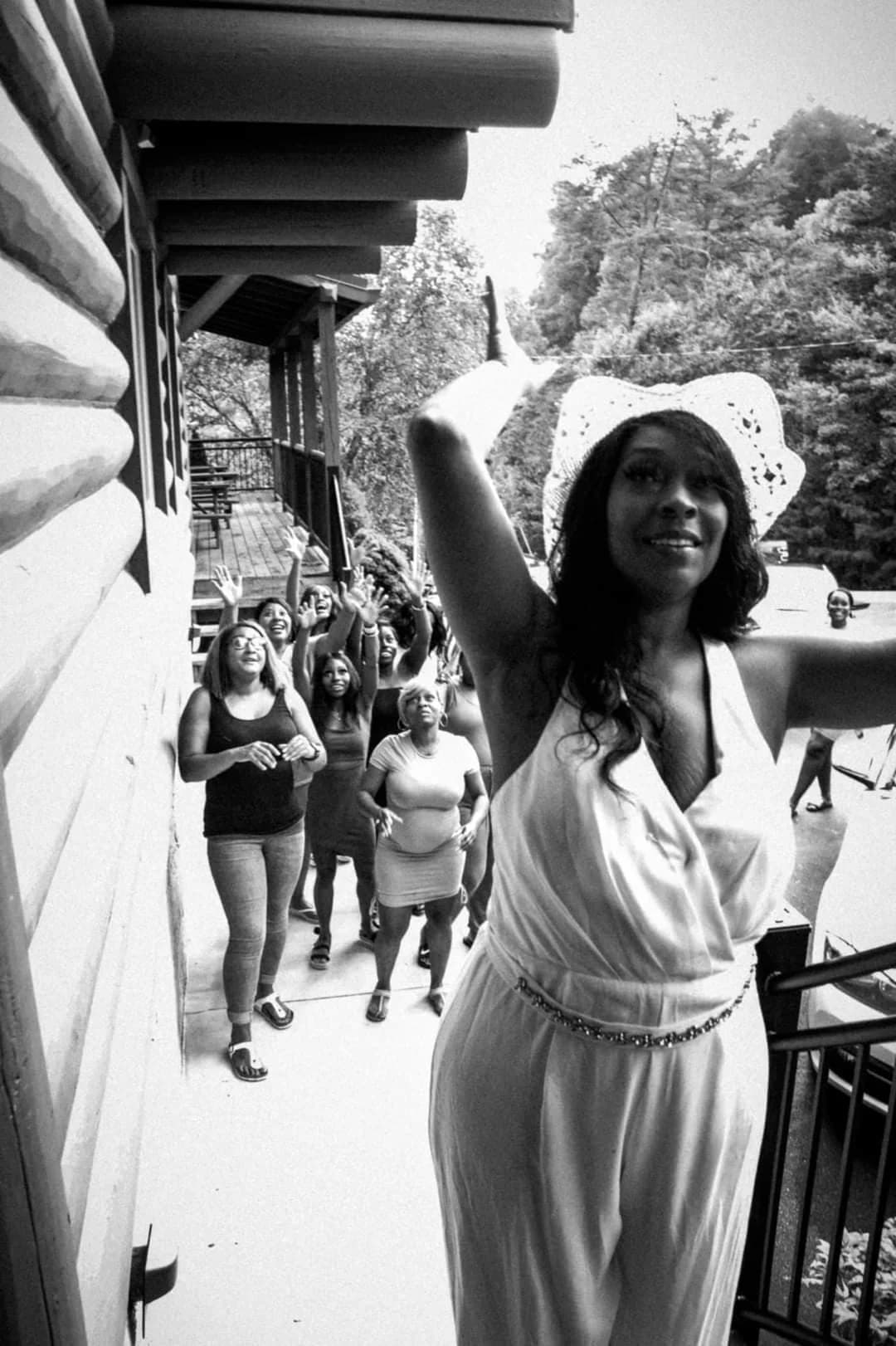 Bride tossing bouquet from rustic cabin balcony at Moose Hollow Lodge in Pigeon Forge near the Smoky Mountains