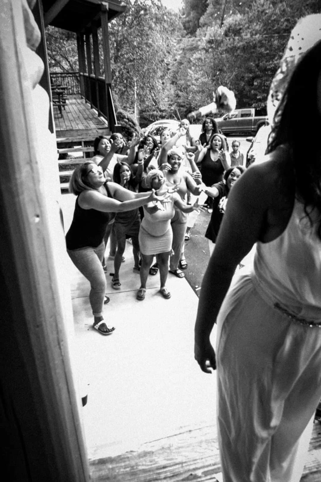 Bride tossing wedding bouquet to guests outdoors at Moose Hollow Lodge in Pigeon Forge near Dollywood