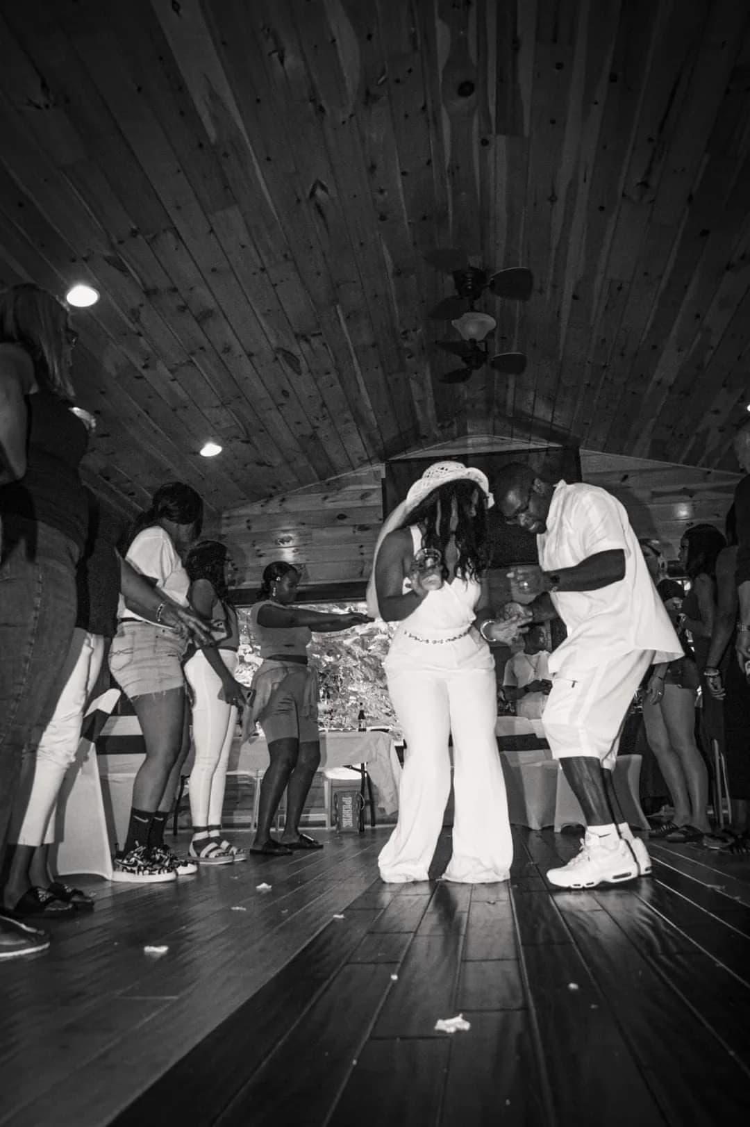 Guests dancing in a rustic wood-paneled wedding reception hall at Moose Hollow Lodge in Pigeon Forge
