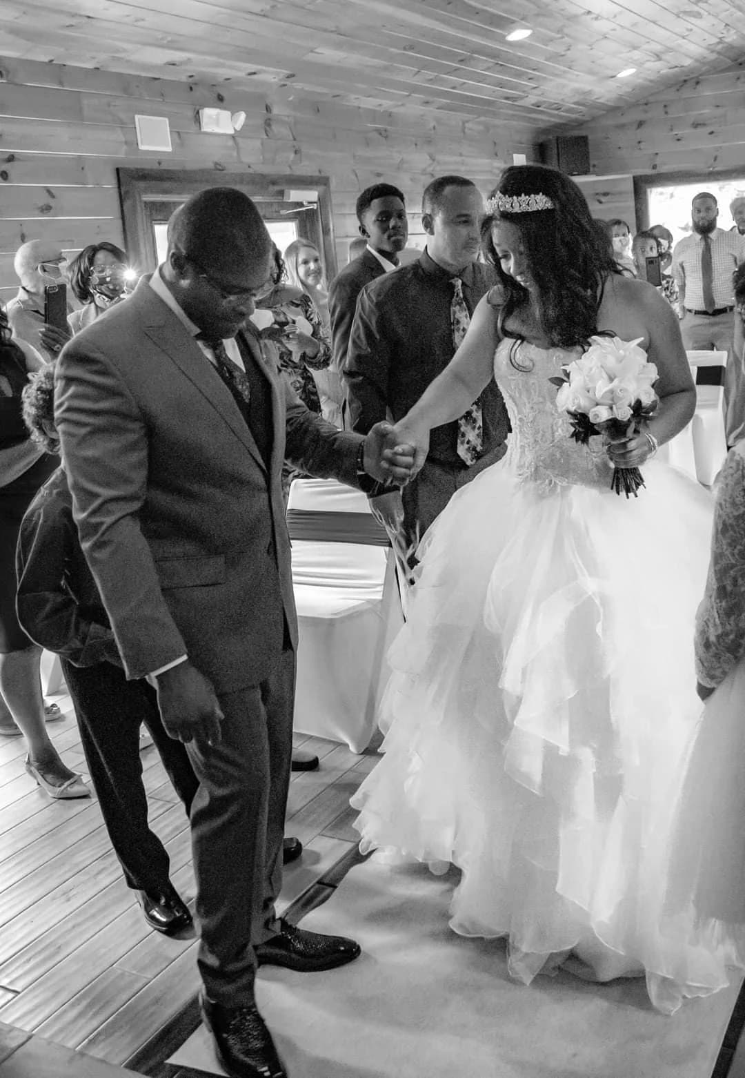 Bride and groom during ceremony in rustic wood-paneled wedding hall at Moose Hollow Lodge in Pigeon Forge
