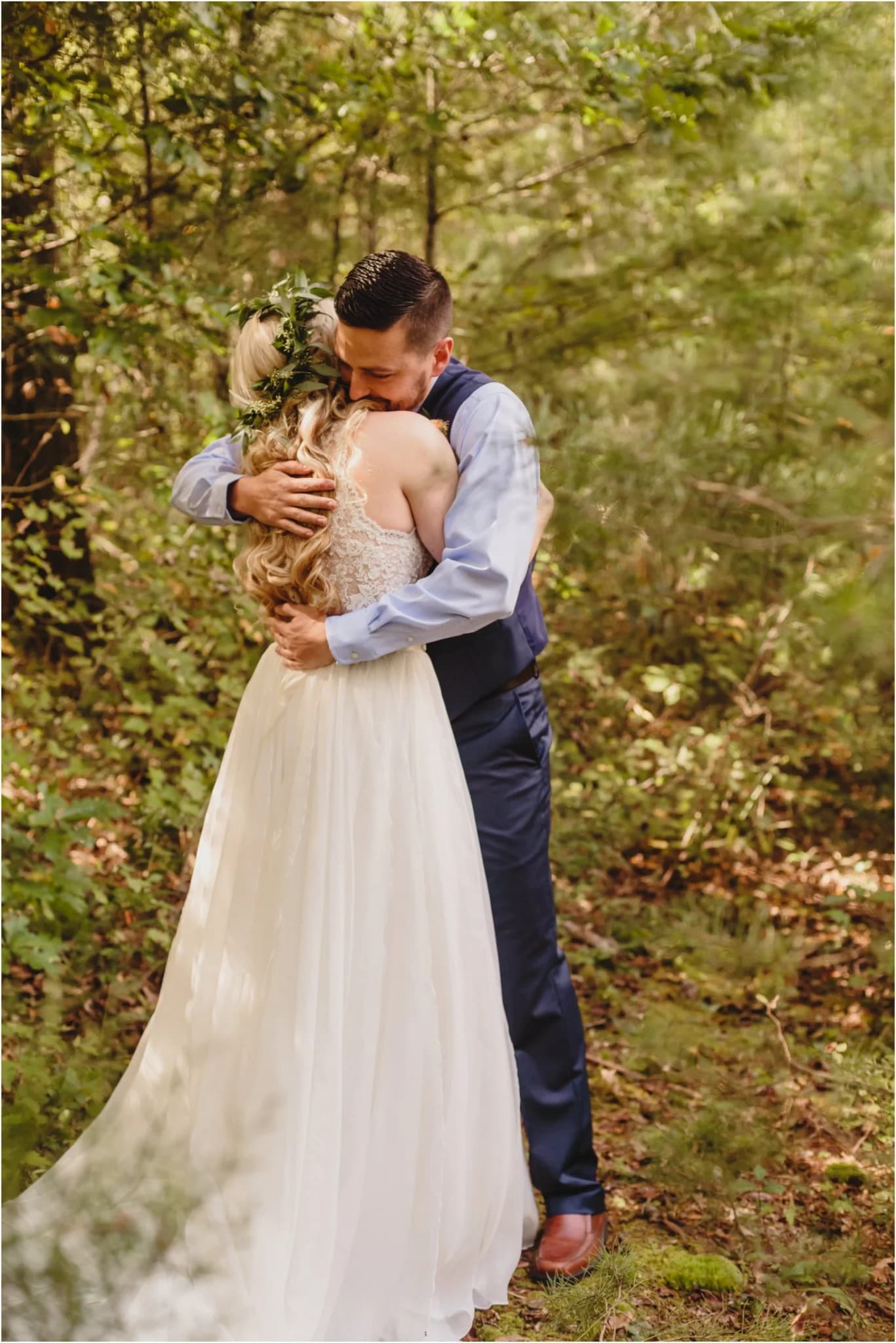 Wedding couple embrace in a lush forest at Moose Hollow Lodge in Pigeon Forge near Dollywood and Smoky Mountains