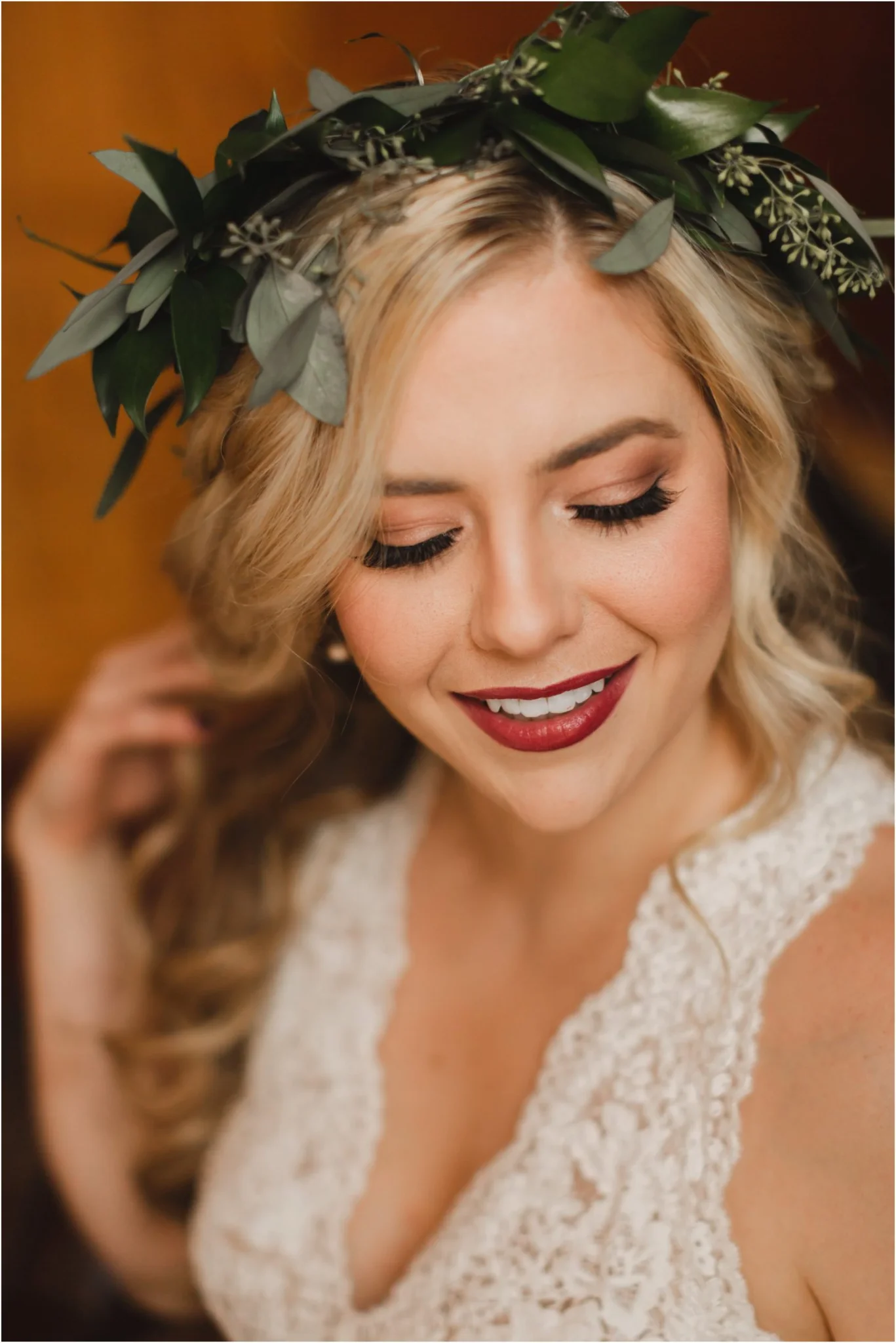 Smiling blonde bride with green leafy crown and white lace dress at Moose Hollow Lodge in Pigeon Forge