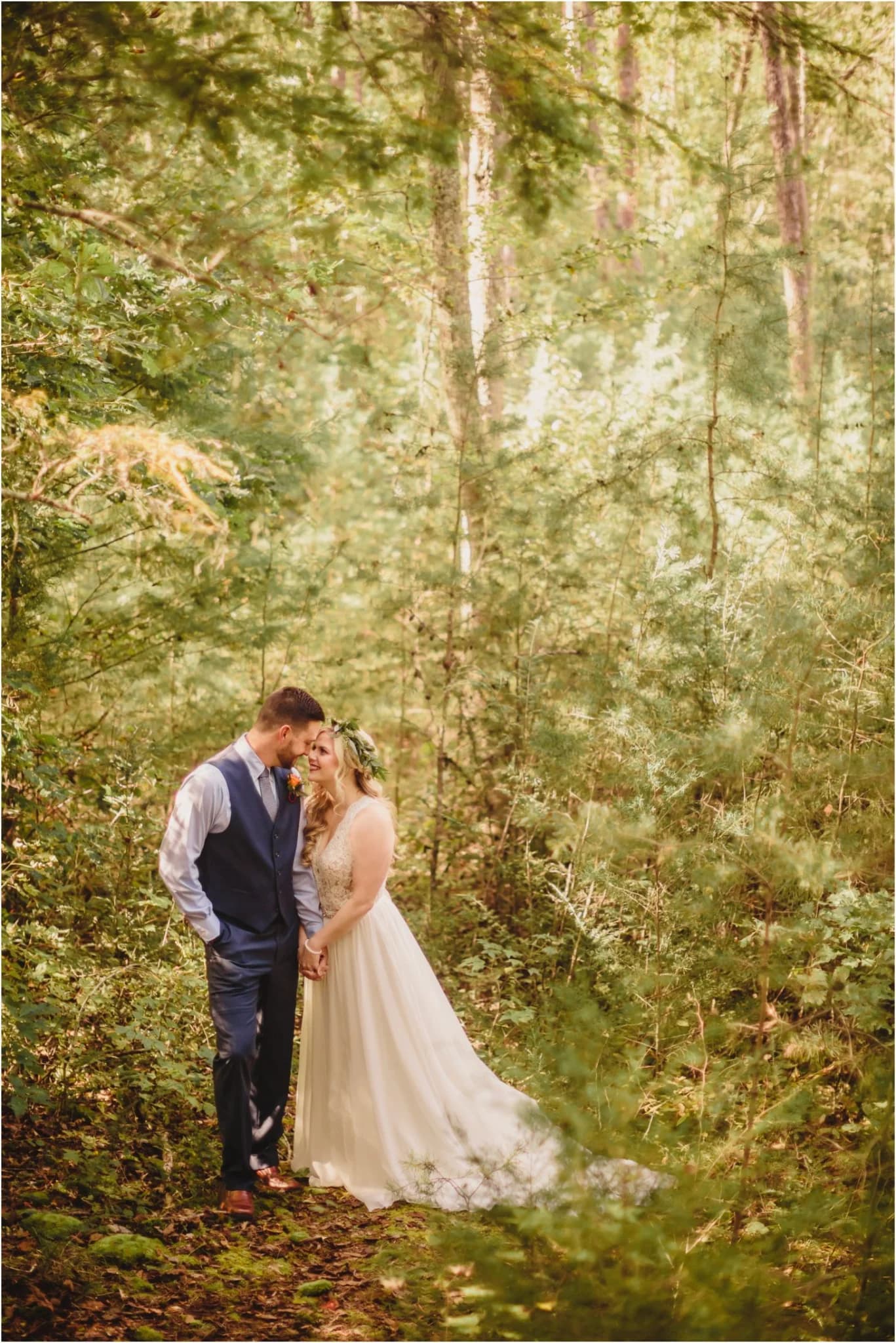 Wedding couple in lush Smoky Mountains forest at Moose Hollow Lodge in Pigeon Forge near Dollywood
