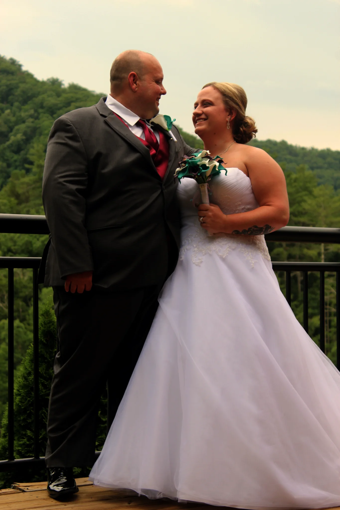 Newlyweds on a deck with Smoky Mountain views at Moose Hollow Lodge in Pigeon Forge near Dollywood