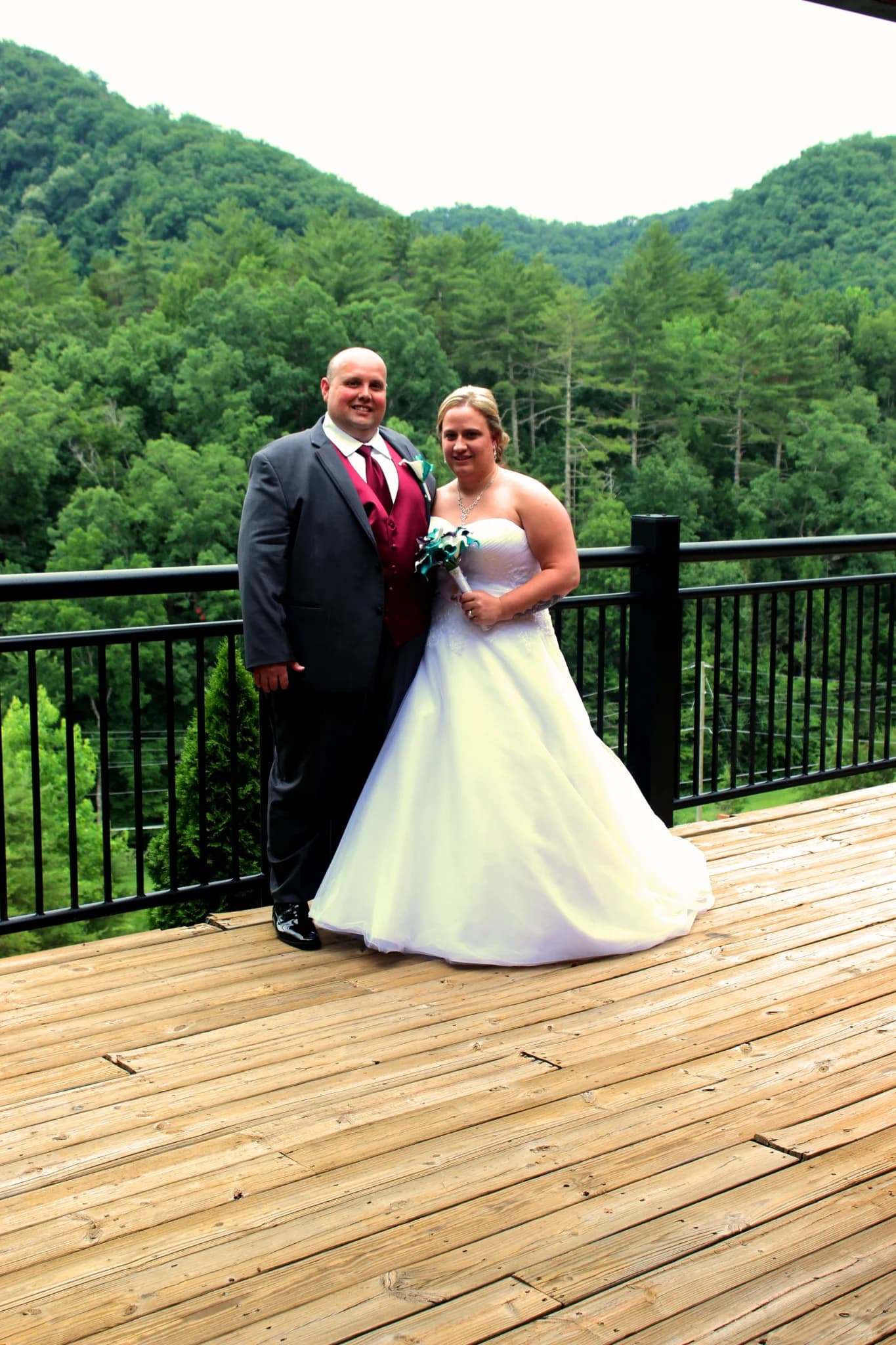 Bride and groom on deck with Smoky Mountains views near Dollywood at Moose Hollow Lodge in Pigeon Forge