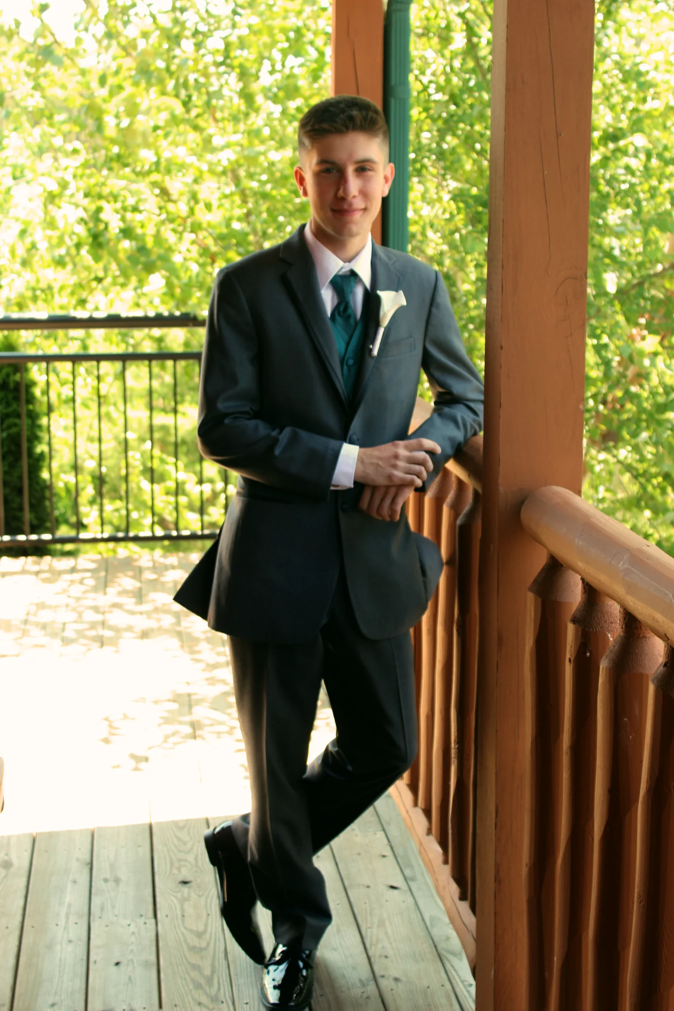 Groom on a rustic wooden deck with forest views at Moose Hollow Lodge in Pigeon Forge near the Smoky Mountains