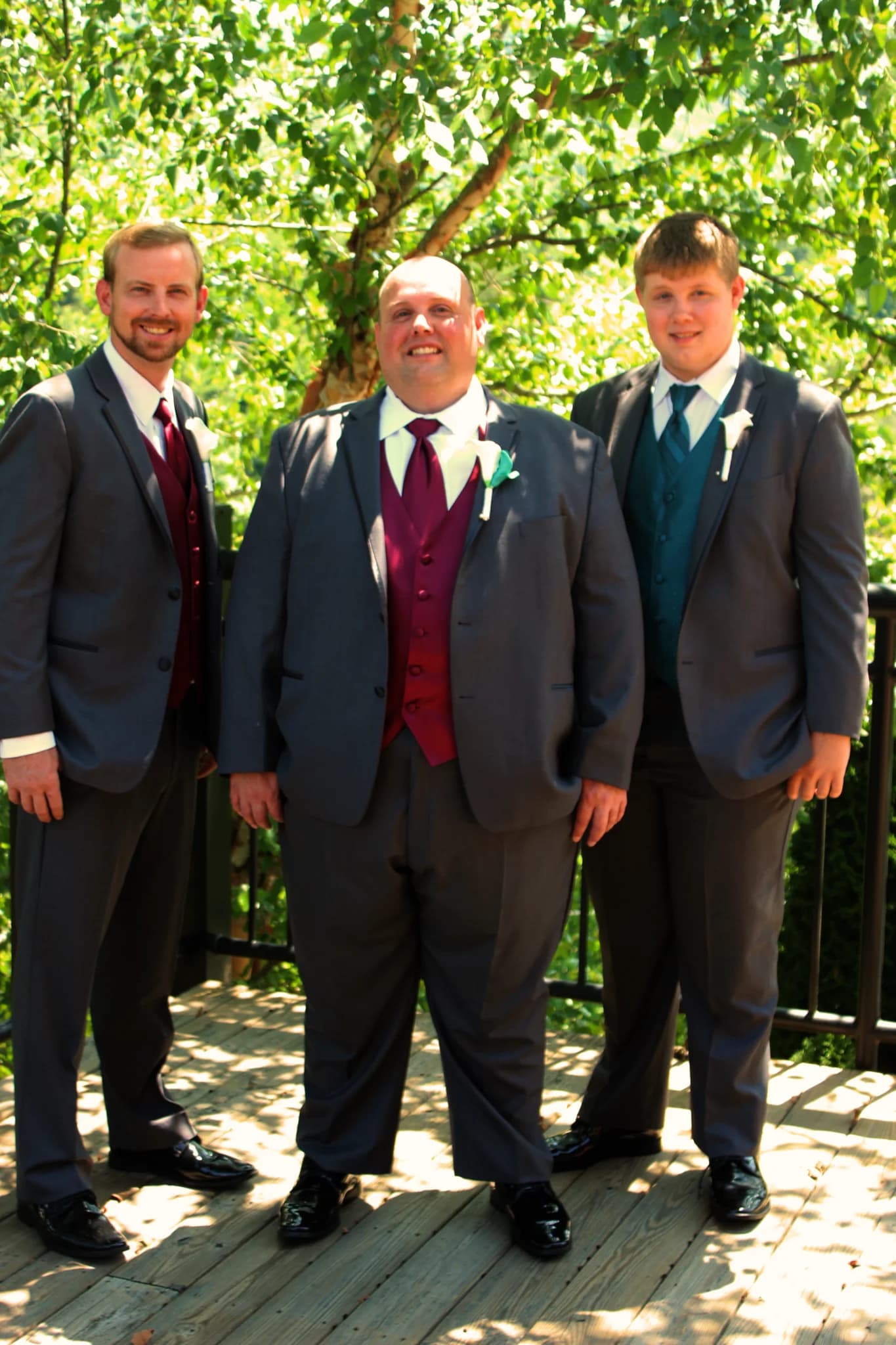 Groom and groomsmen in grey suits on an outdoor deck at Moose Hollow Lodge in Pigeon Forge near Smoky Mountains