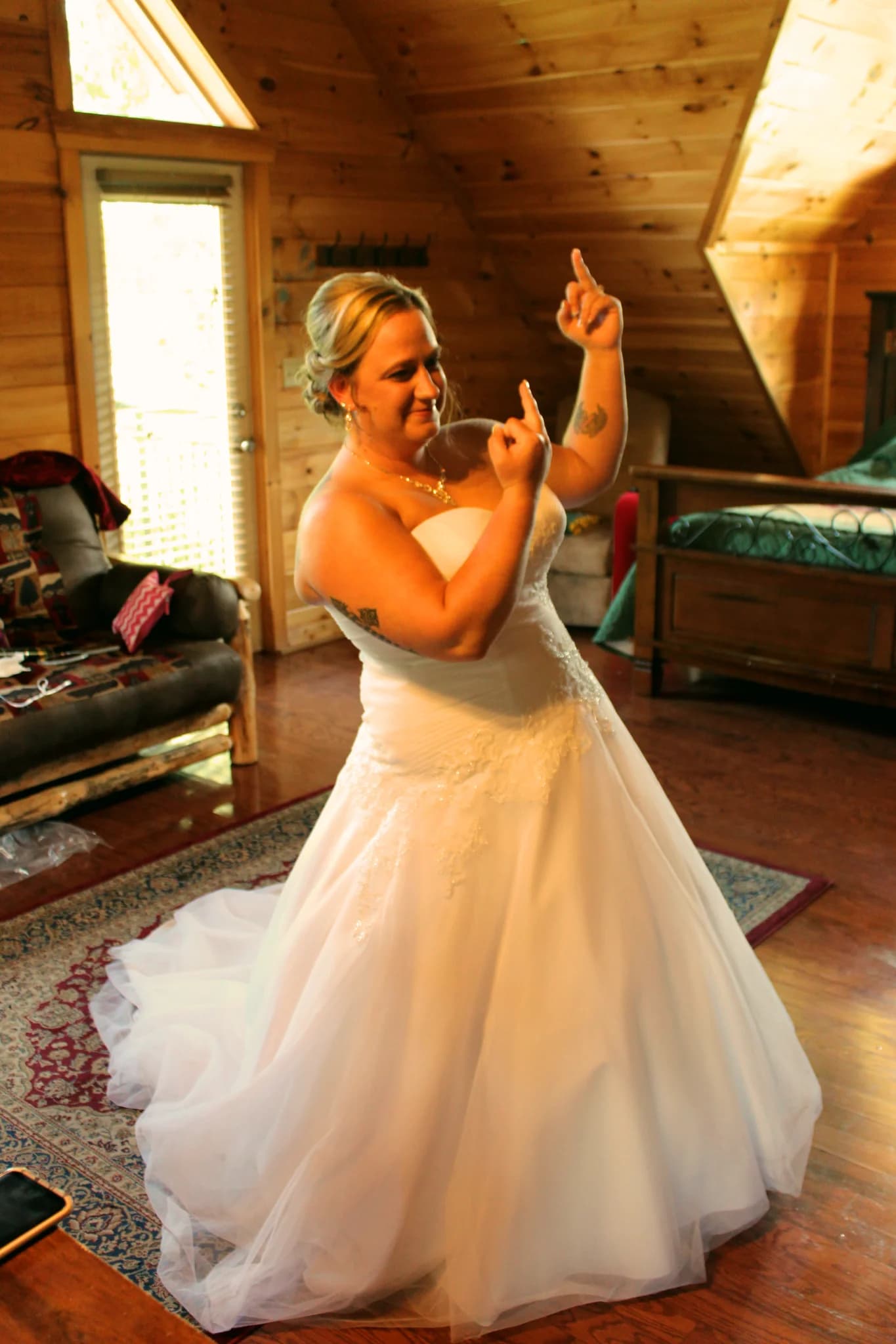 Bride in white gown in rustic log cabin bedroom with wood walls at Moose Hollow Lodge in Pigeon Forge