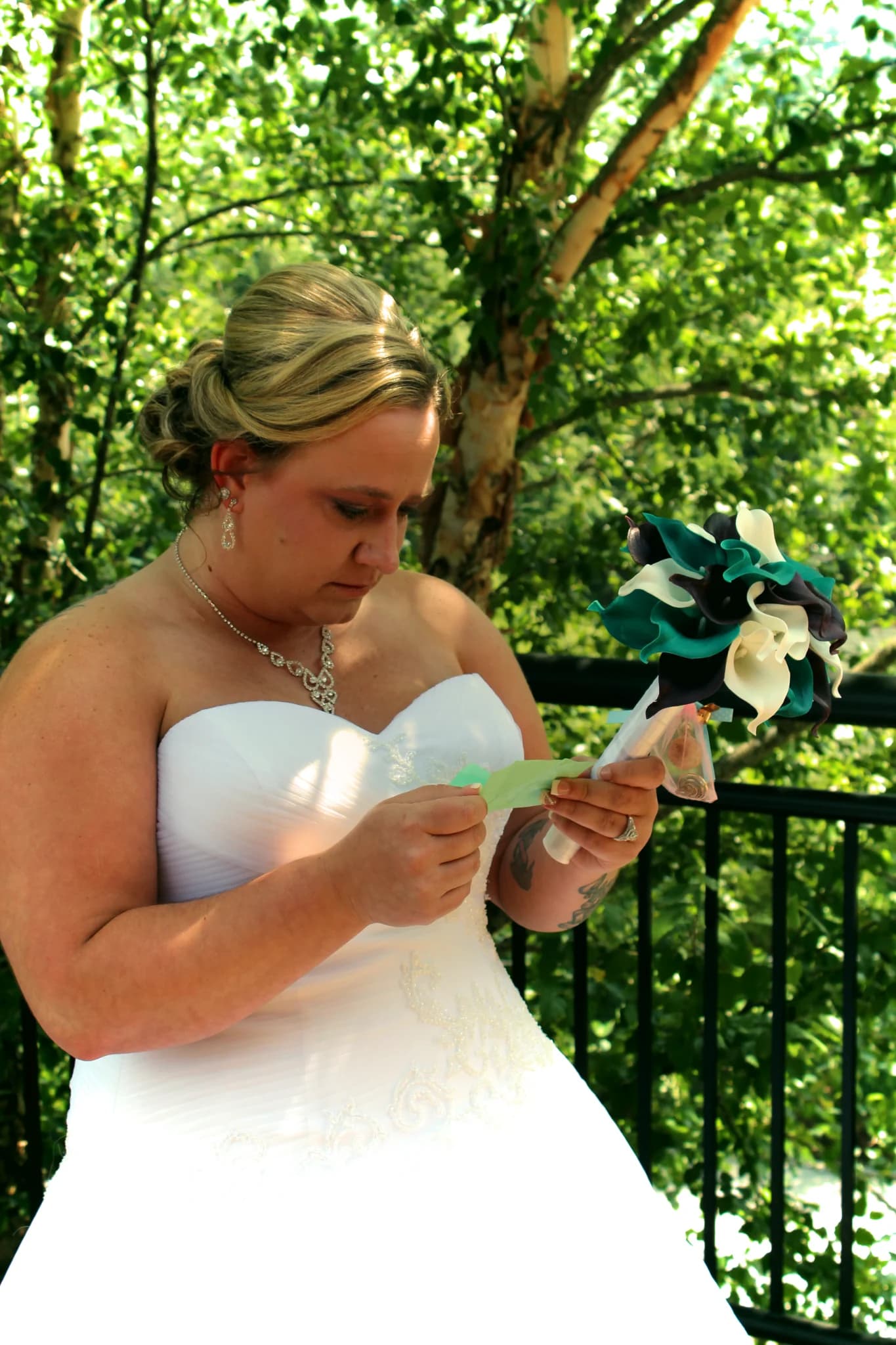 Bride reading a letter on an outdoor deck near Dollywood at Moose Hollow Lodge in Pigeon Forge near Smoky Mountains