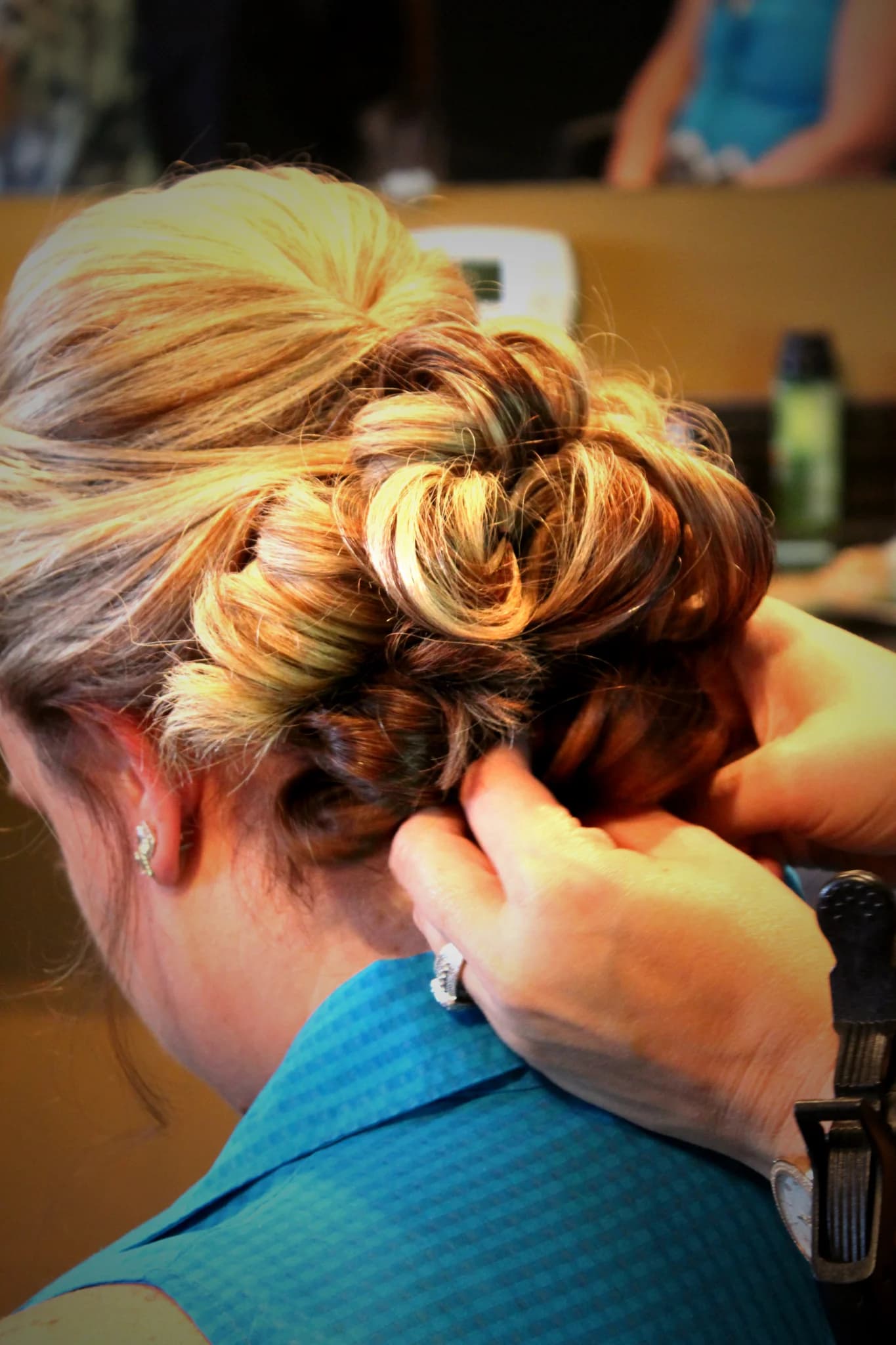 Bride receiving an elegant hair updo during wedding prep at Moose Hollow Lodge in Pigeon Forge