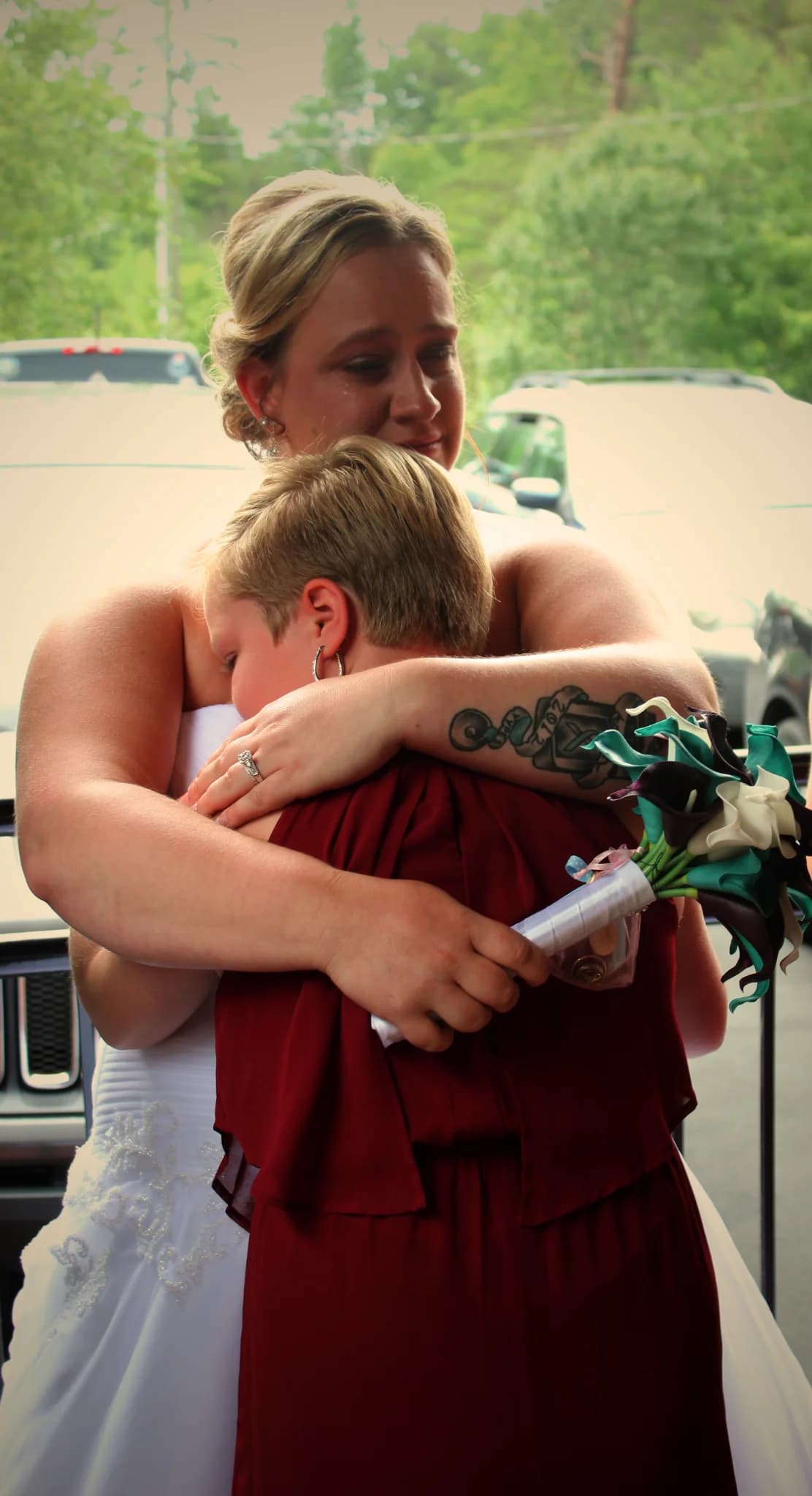 Bride sharing emotional outdoor hug near Smoky Mountains at Moose Hollow Lodge in Pigeon Forge