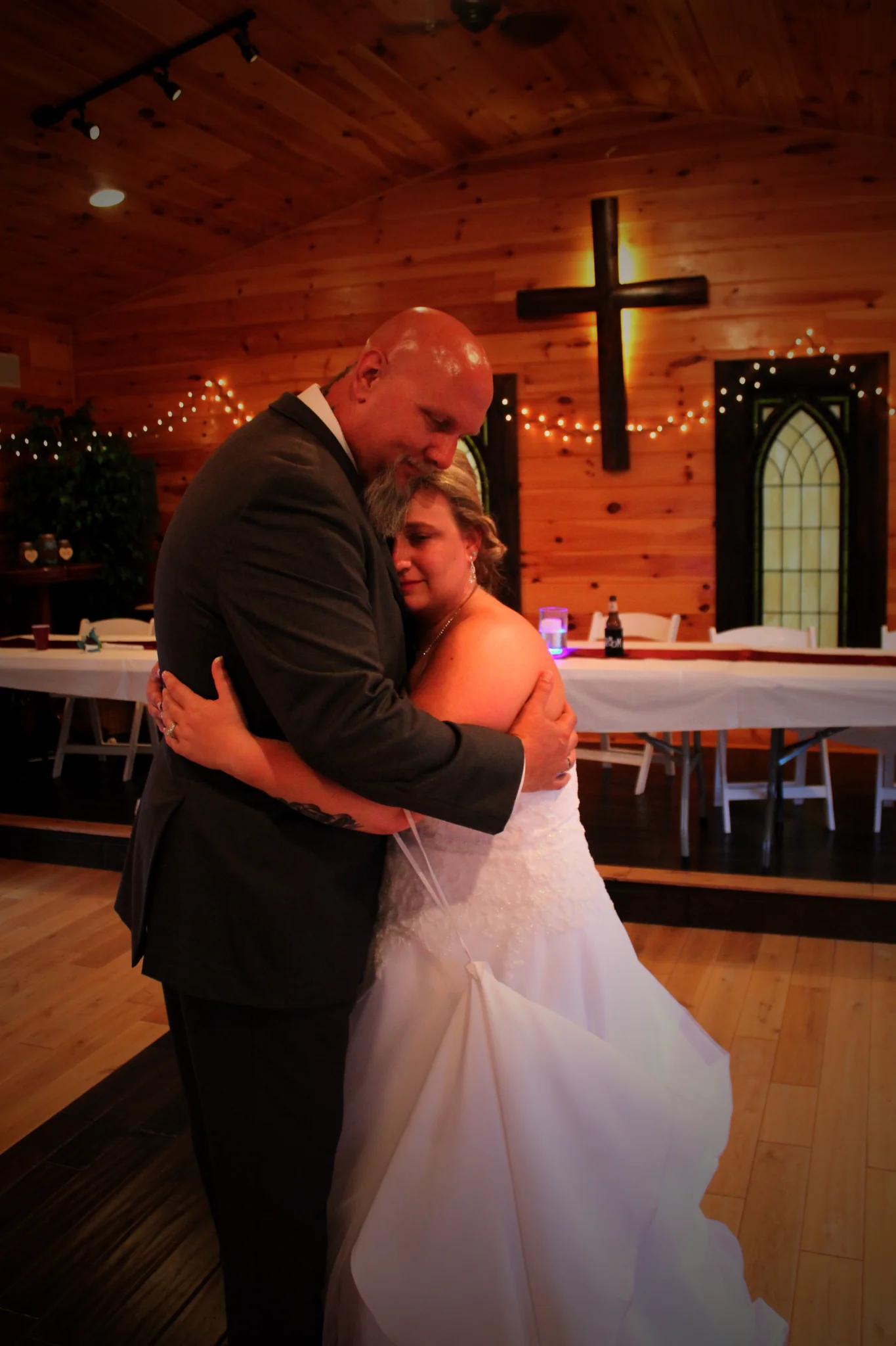 Rustic wedding chapel with wood walls and cross for a first dance at Moose Hollow Lodge in Pigeon Forge.