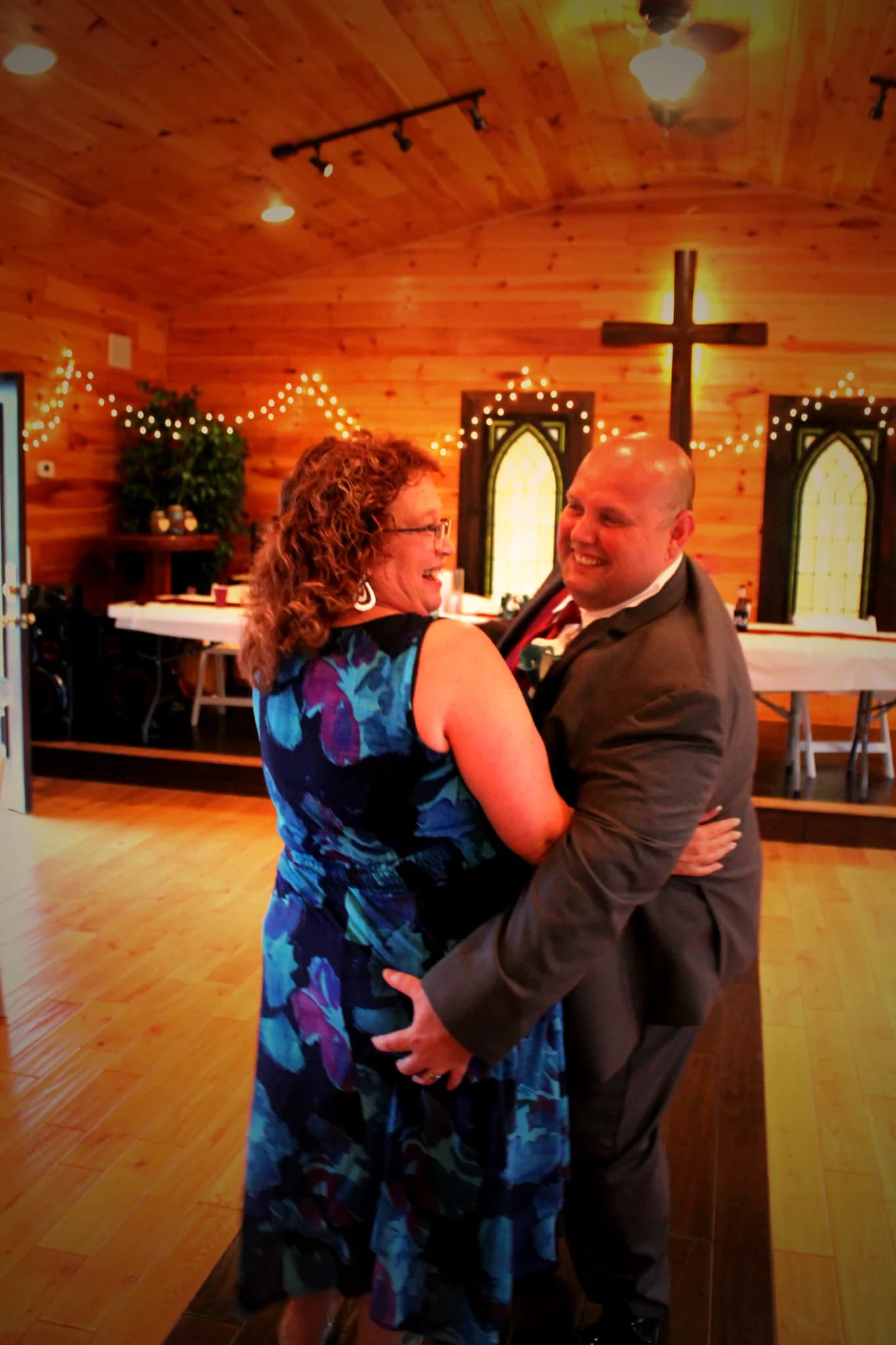 Rustic wood-paneled wedding chapel with string lights and cross at Moose Hollow Lodge in Pigeon Forge