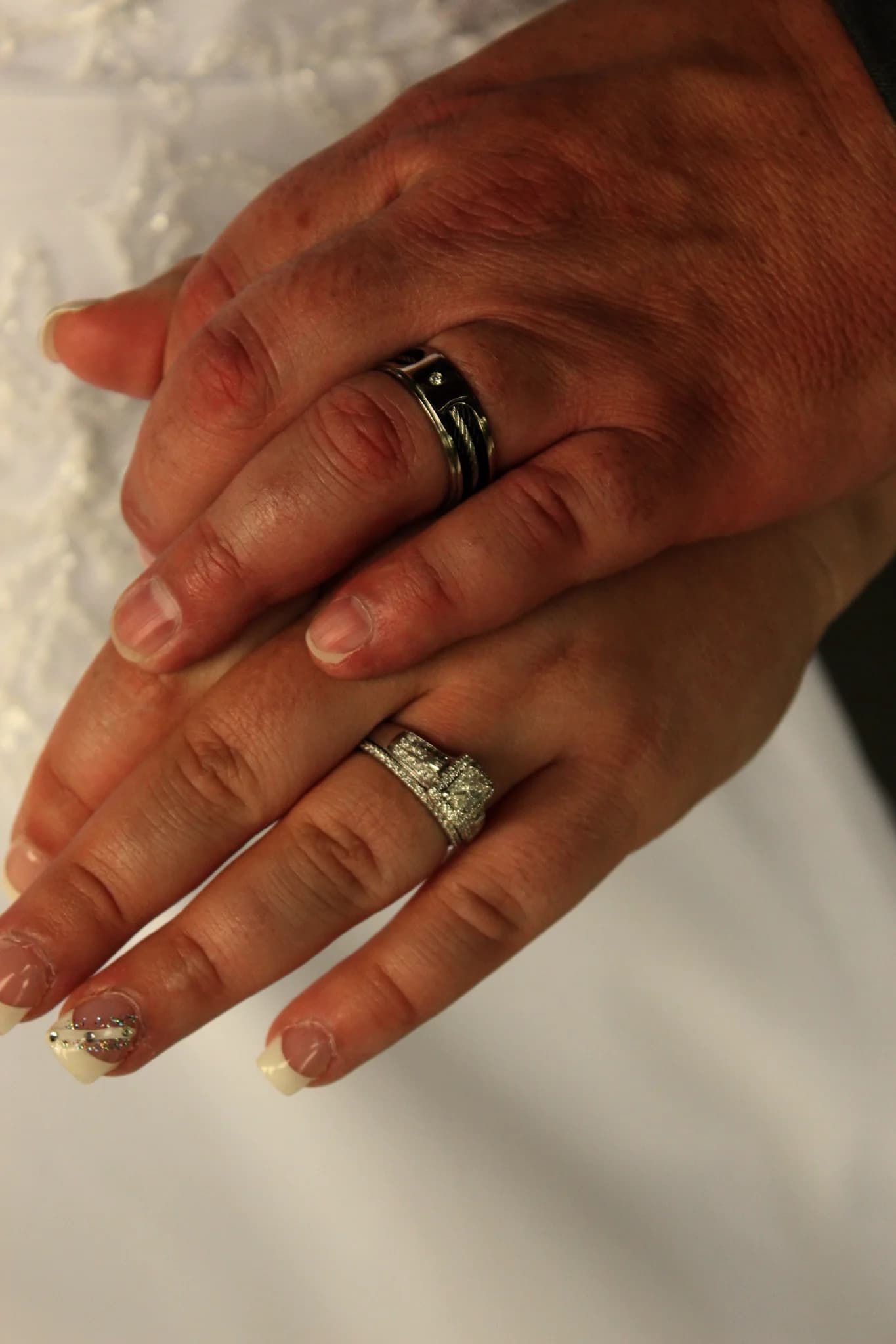 Close-up of wedding rings on joined hands at Moose Hollow Lodge in Pigeon Forge