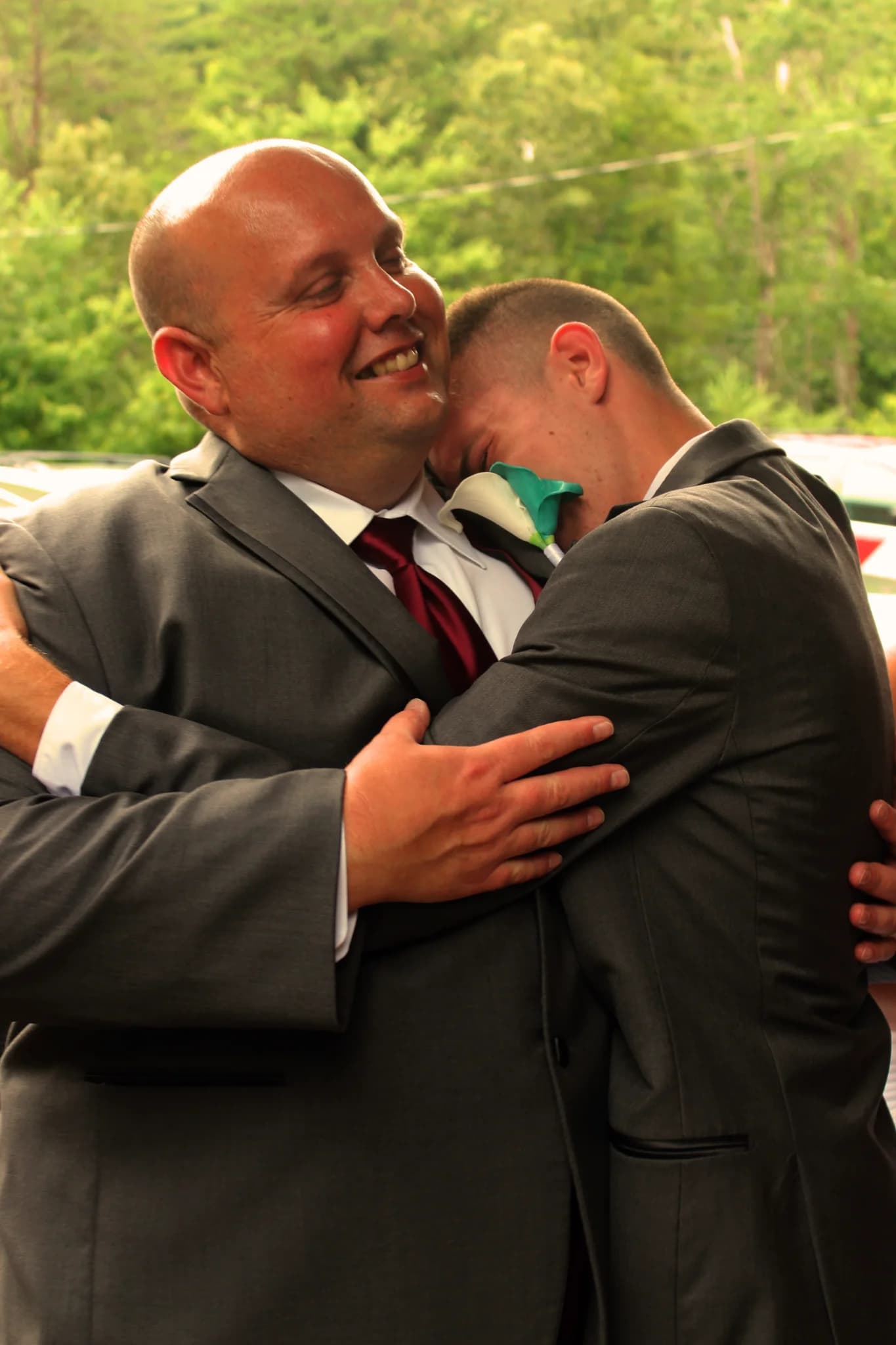 Emotional wedding hug outdoors with forest views at Moose Hollow Lodge in Pigeon Forge near Smoky Mountains