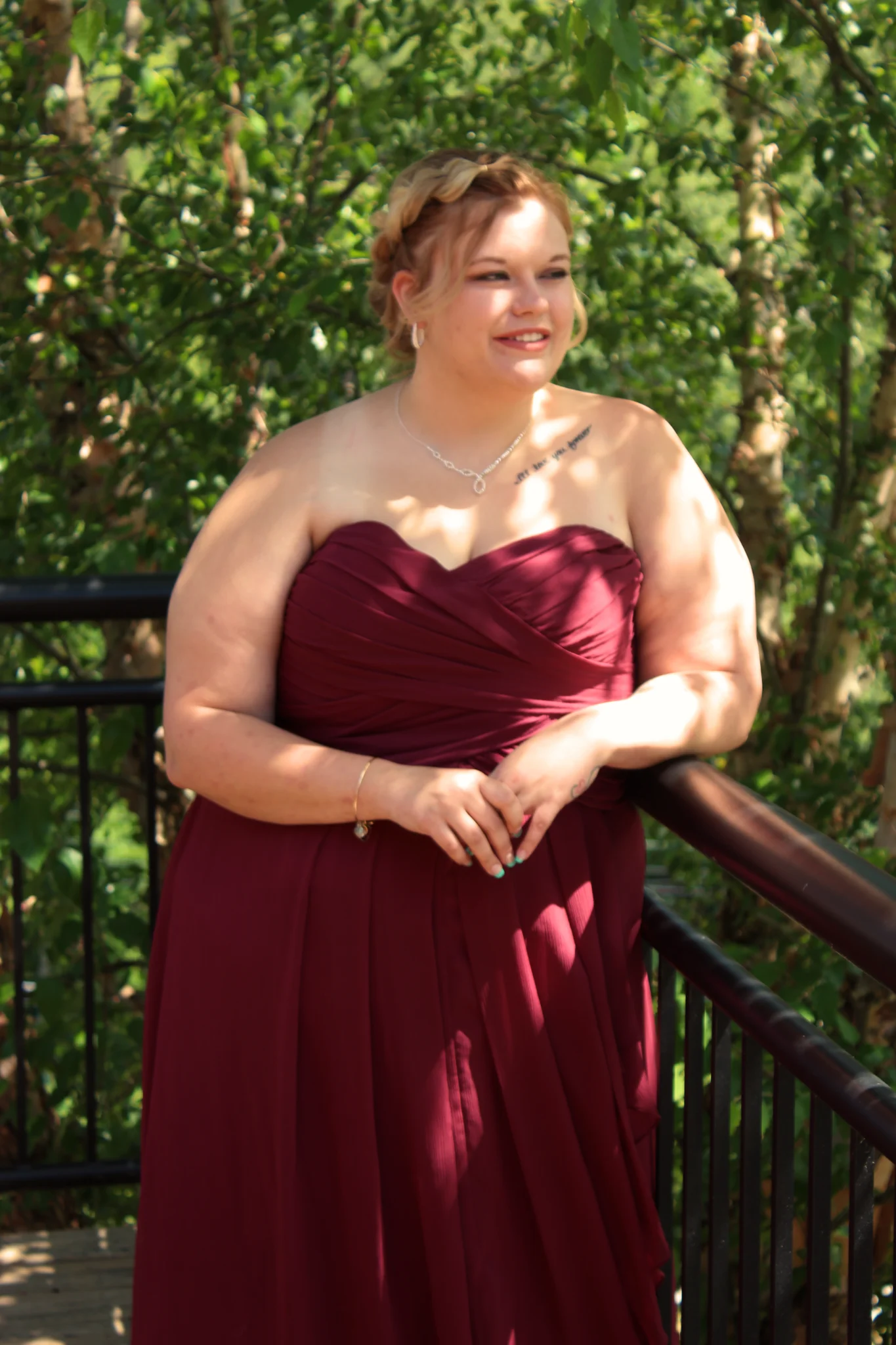 Bridesmaid in burgundy dress on scenic deck at Moose Hollow Lodge in Pigeon Forge near Smoky Mountains