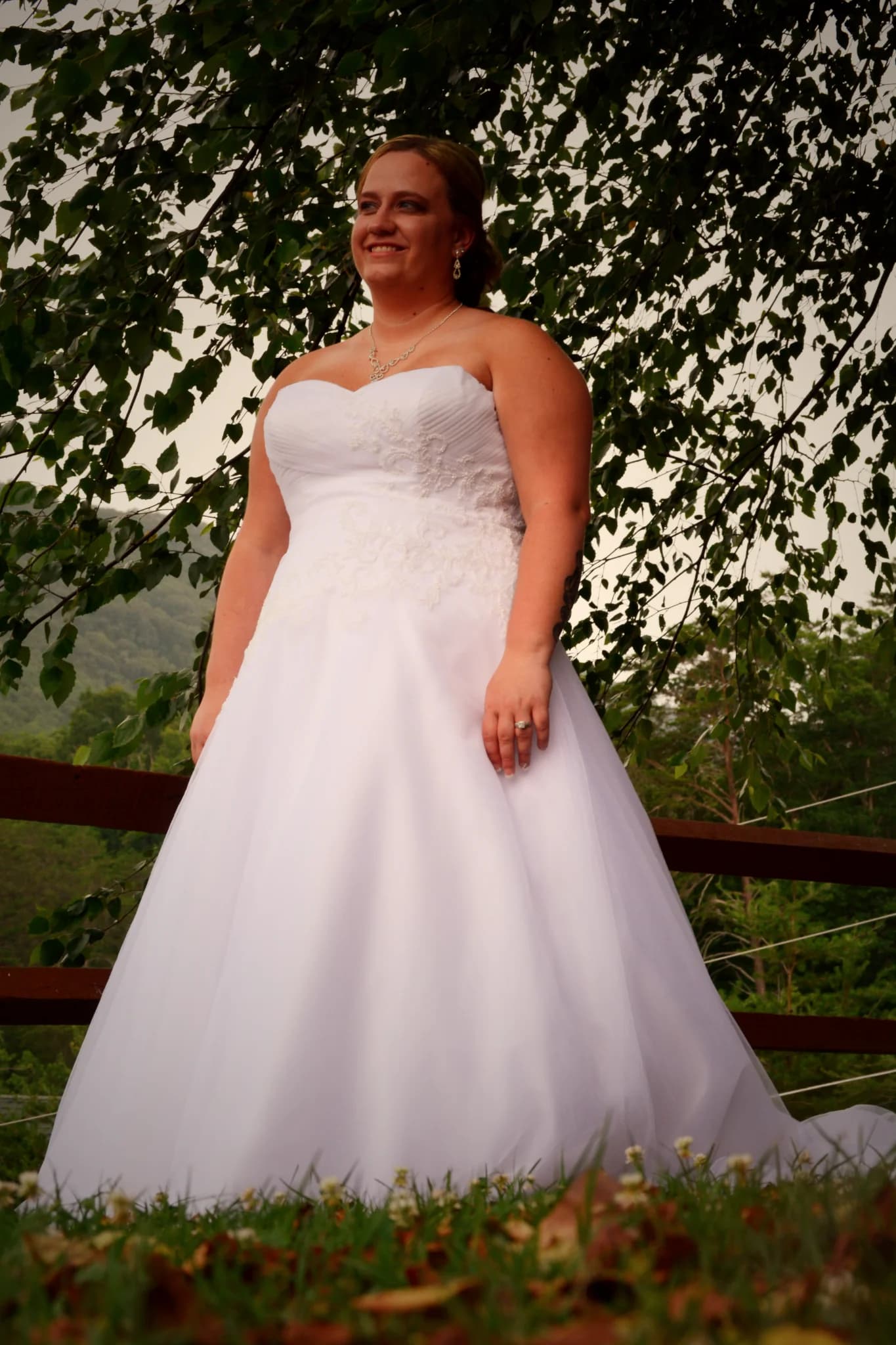 Bride in white gown on scenic outdoor deck at Moose Hollow Lodge in Pigeon Forge near the Smoky Mountains