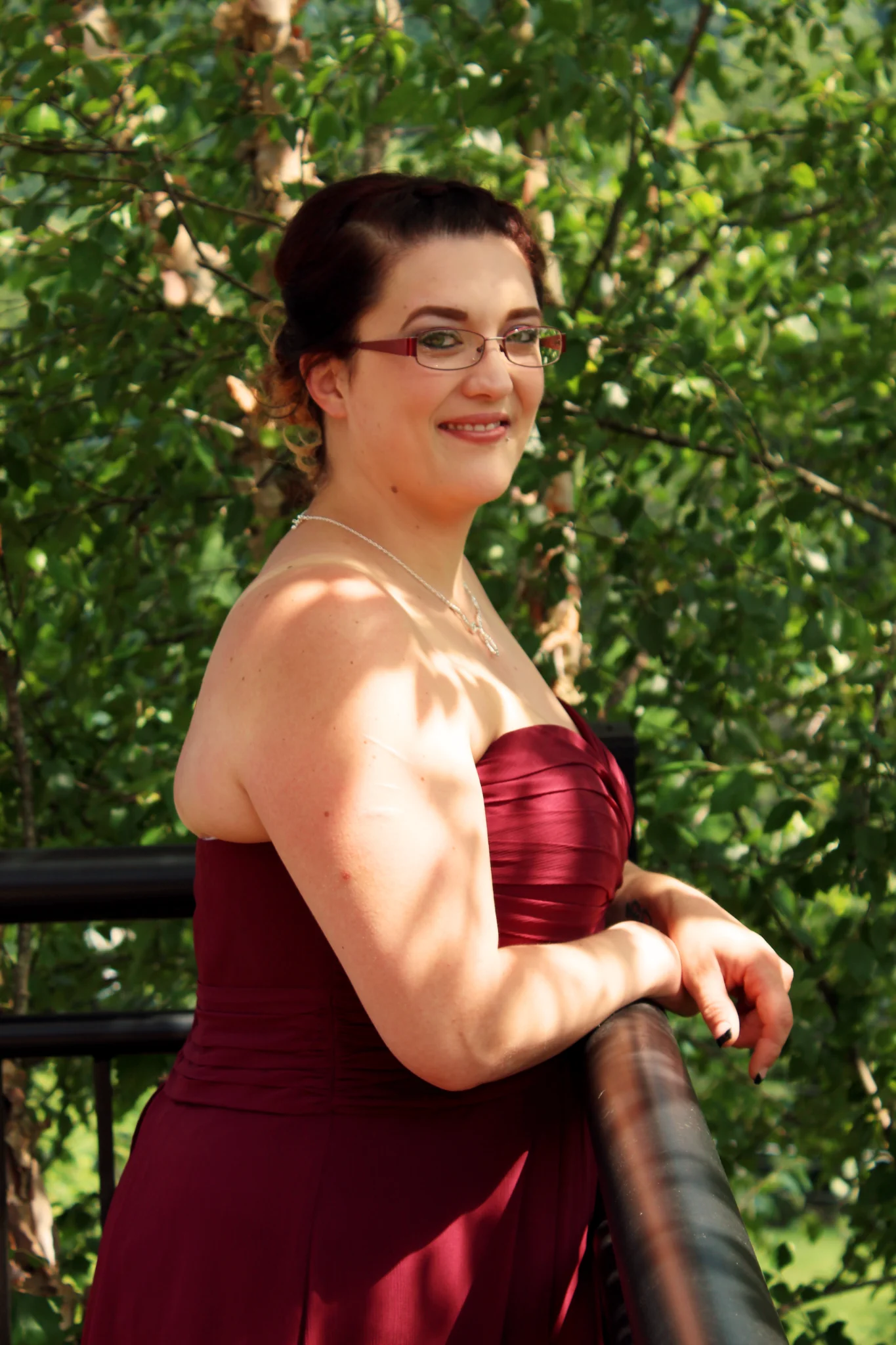 Woman in burgundy dress on a deck with forest views at Moose Hollow Lodge in Pigeon Forge near Dollywood and Smoky Mountains