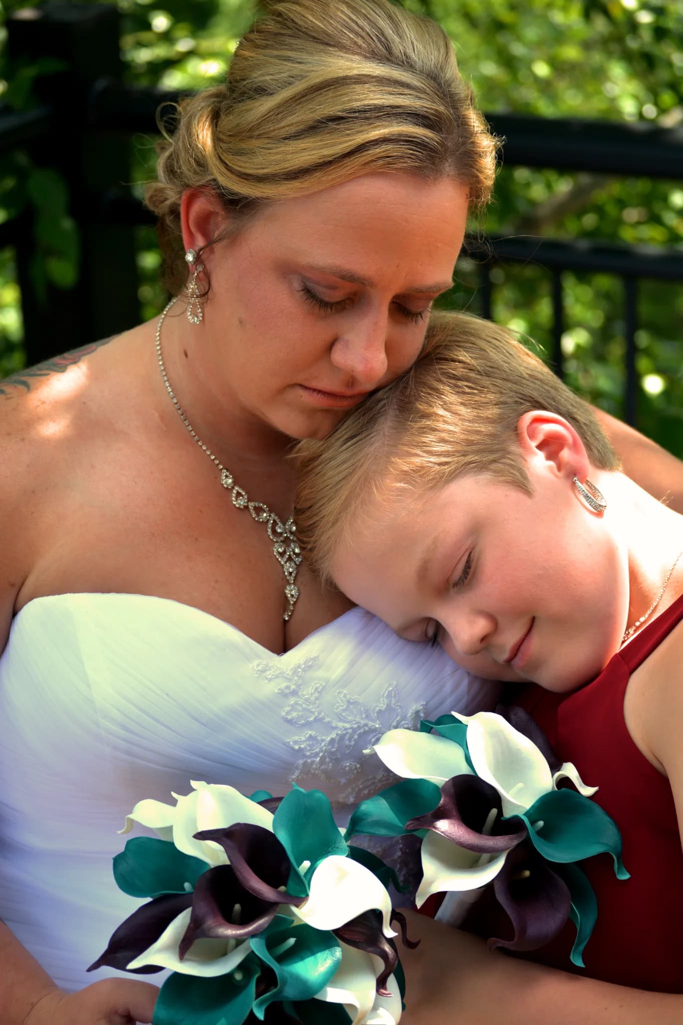 Bride and child with bouquets on an outdoor deck at Moose Hollow Lodge in Pigeon Forge near the Smoky Mountains
